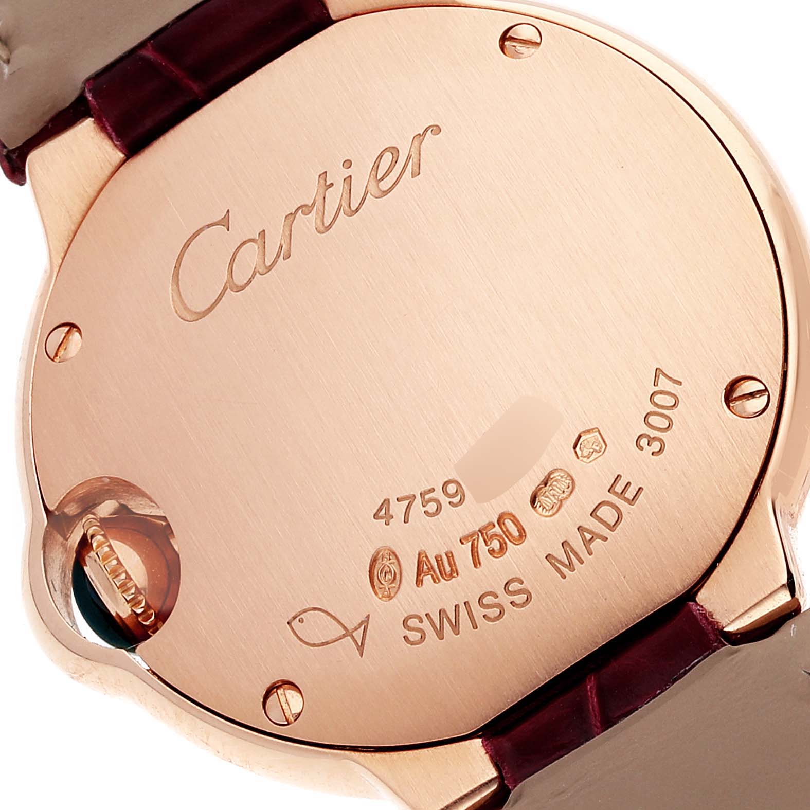 This image shows the case back of a Cartier Ballon Bleu WE902050 Women
s Rose Gold Silver Dial WE902050 Women
s Rose Gold Silver Dial watch with engraved details and part of the leather strap.