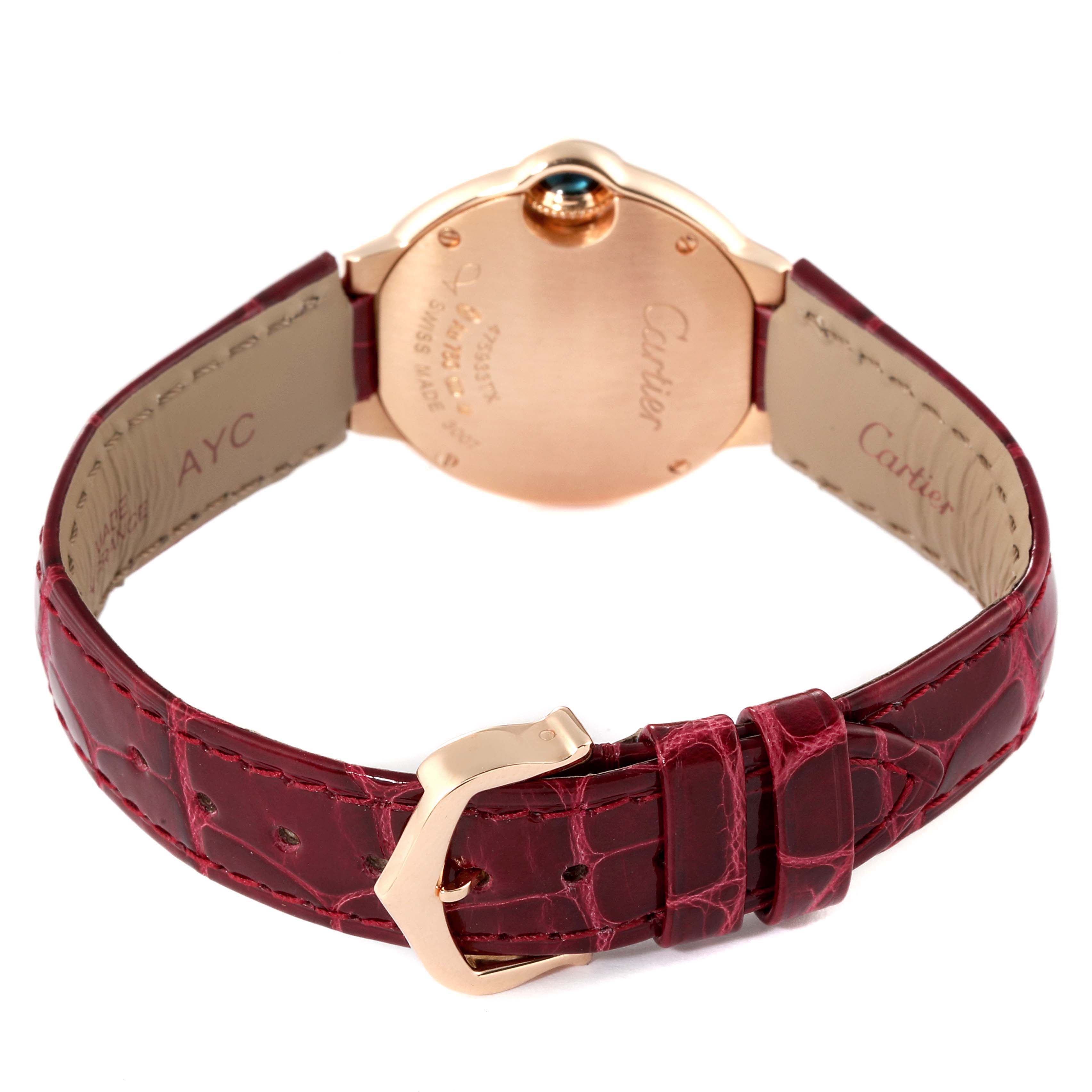 The image shows the back view of a Cartier Ballon Bleu WE902050 Women
s Rose Gold Silver Dial WE902050 Women
s Rose Gold Silver Dial watch, highlighting the red leather strap and gold clasp.
