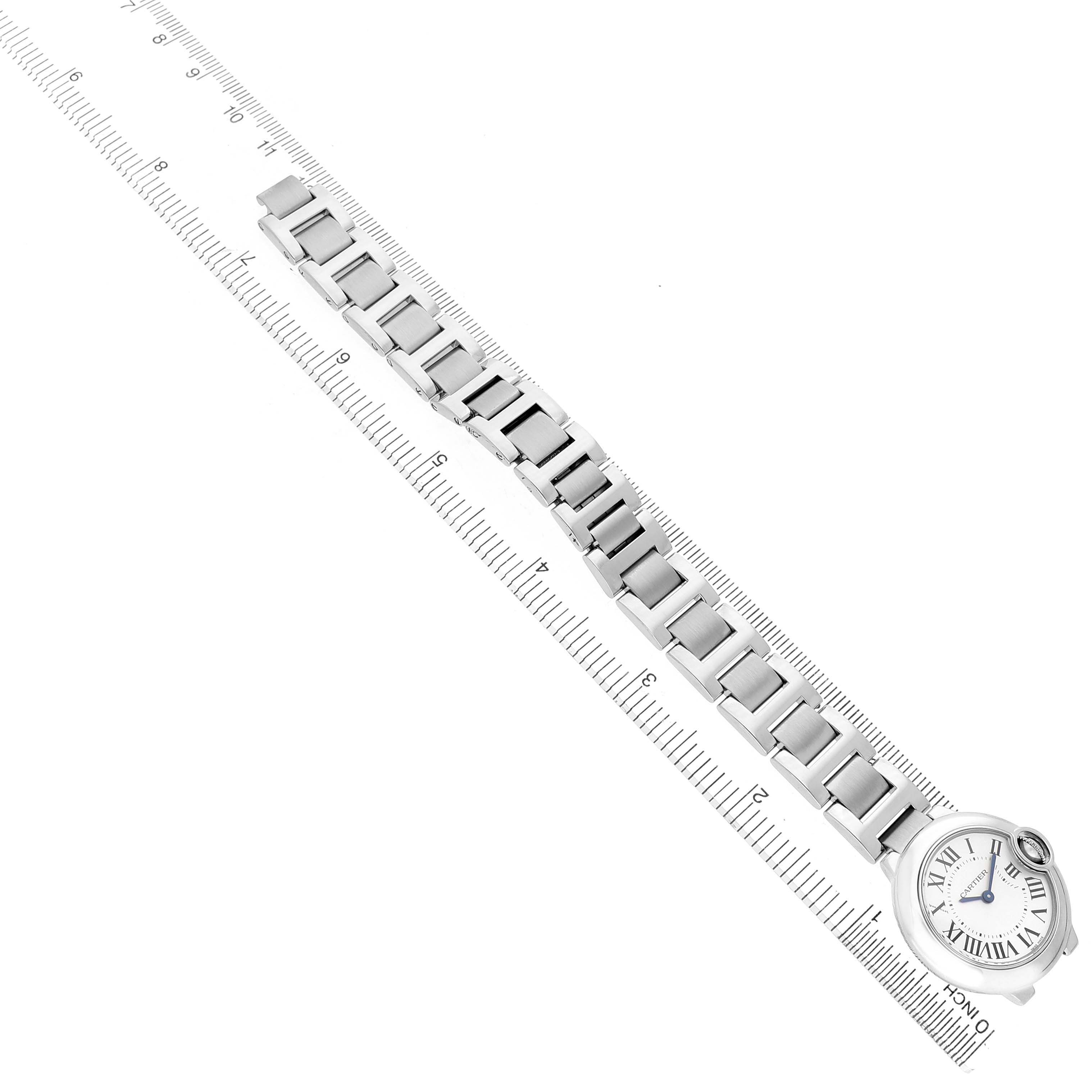 The image shows a Cartier Ballon Bleu W69010Z4 Women's Stainless Steel Silver Dial watch, focusing on the face and full metal bracelet laid out next to a ruler.