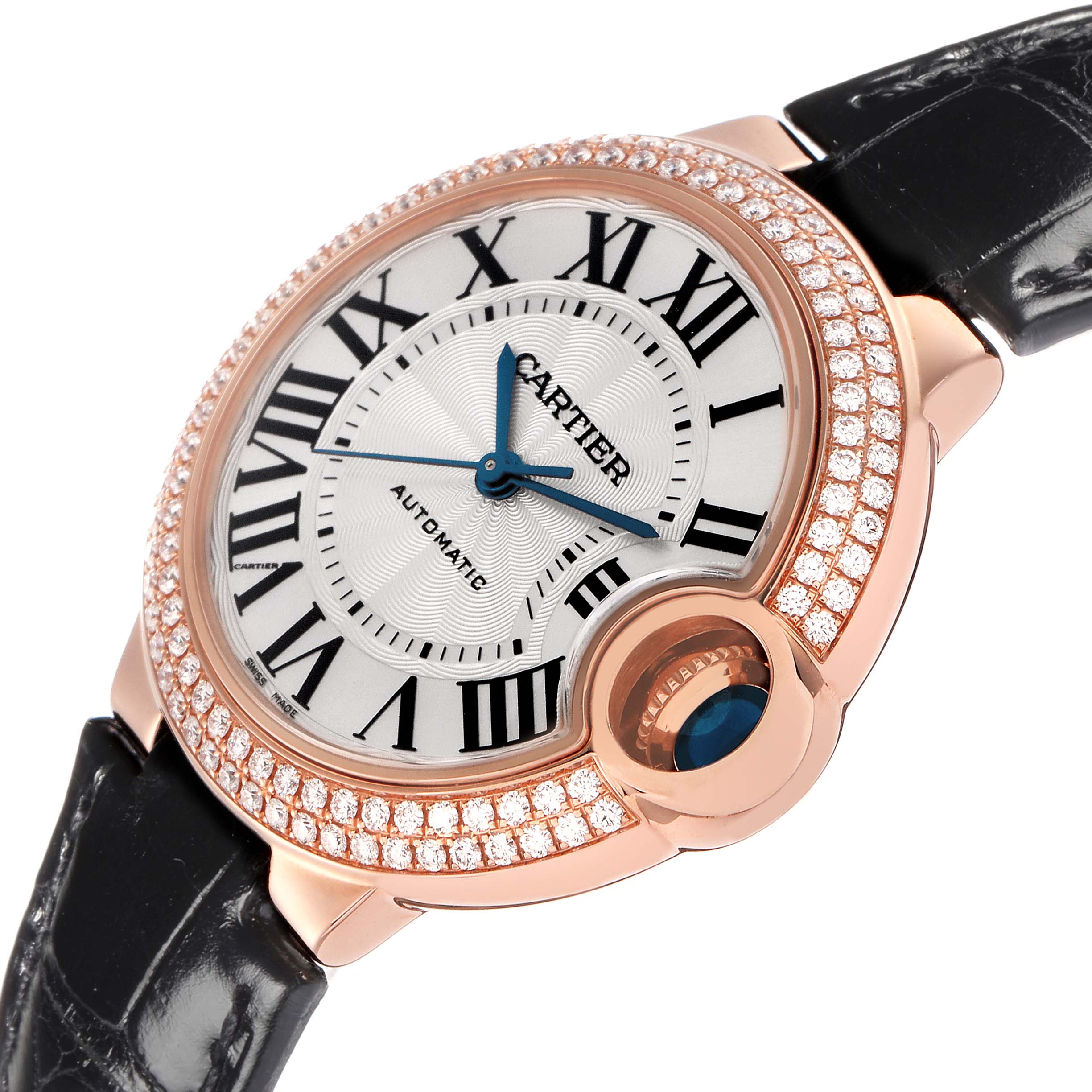 The Cartier Ballon Bleu WE902066 Women
s Rose Gold Silver Dial WE902066 Women
s Rose Gold Silver Dial watch is shown at a slight angle, highlighting its round case, diamond bezel, and blue cabochon crown.