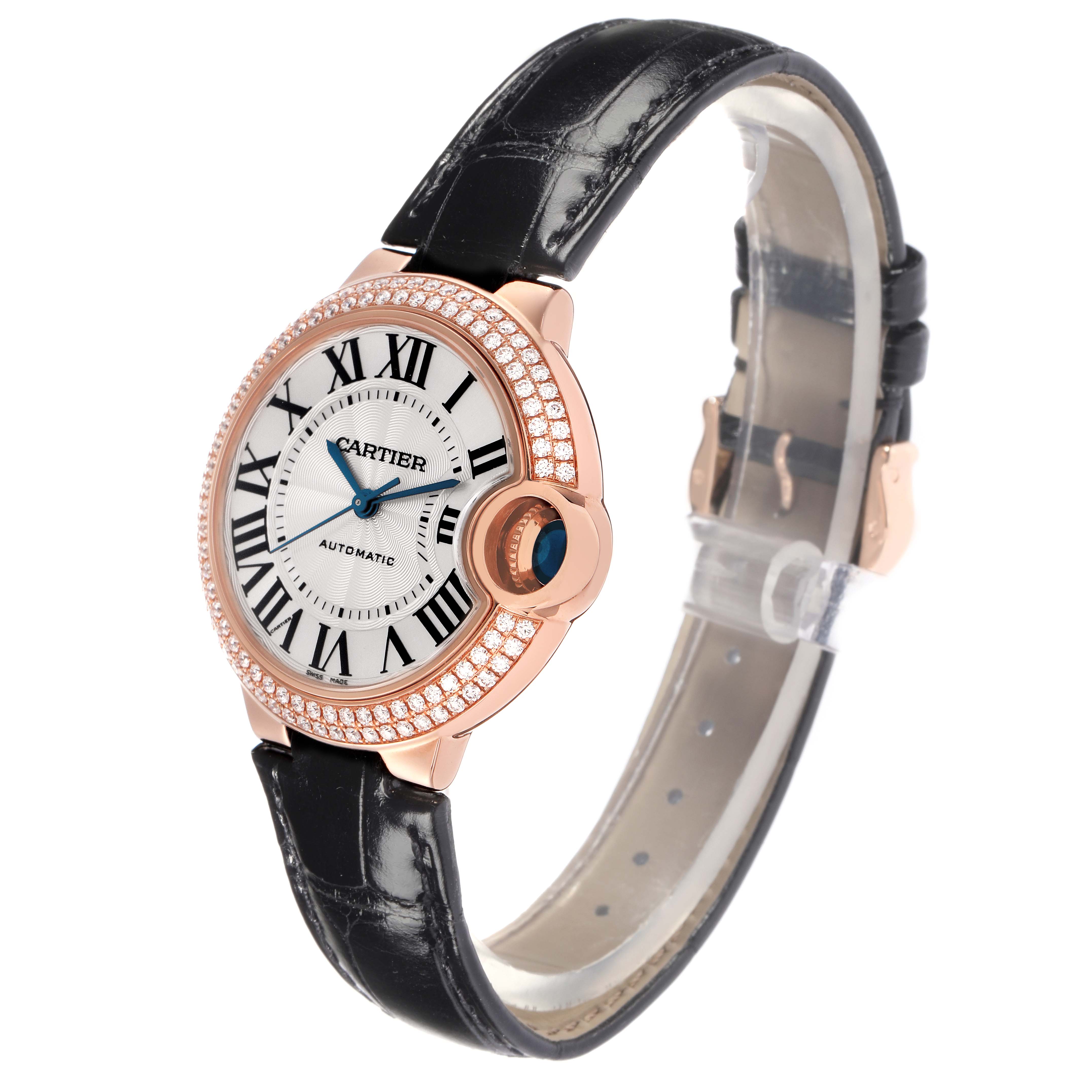 The Cartier Ballon Bleu WE902066 Women
s Rose Gold Silver Dial WE902066 Women
s Rose Gold Silver Dial watch is shown at a slight angle, highlighting the face, crown, and black leather strap.