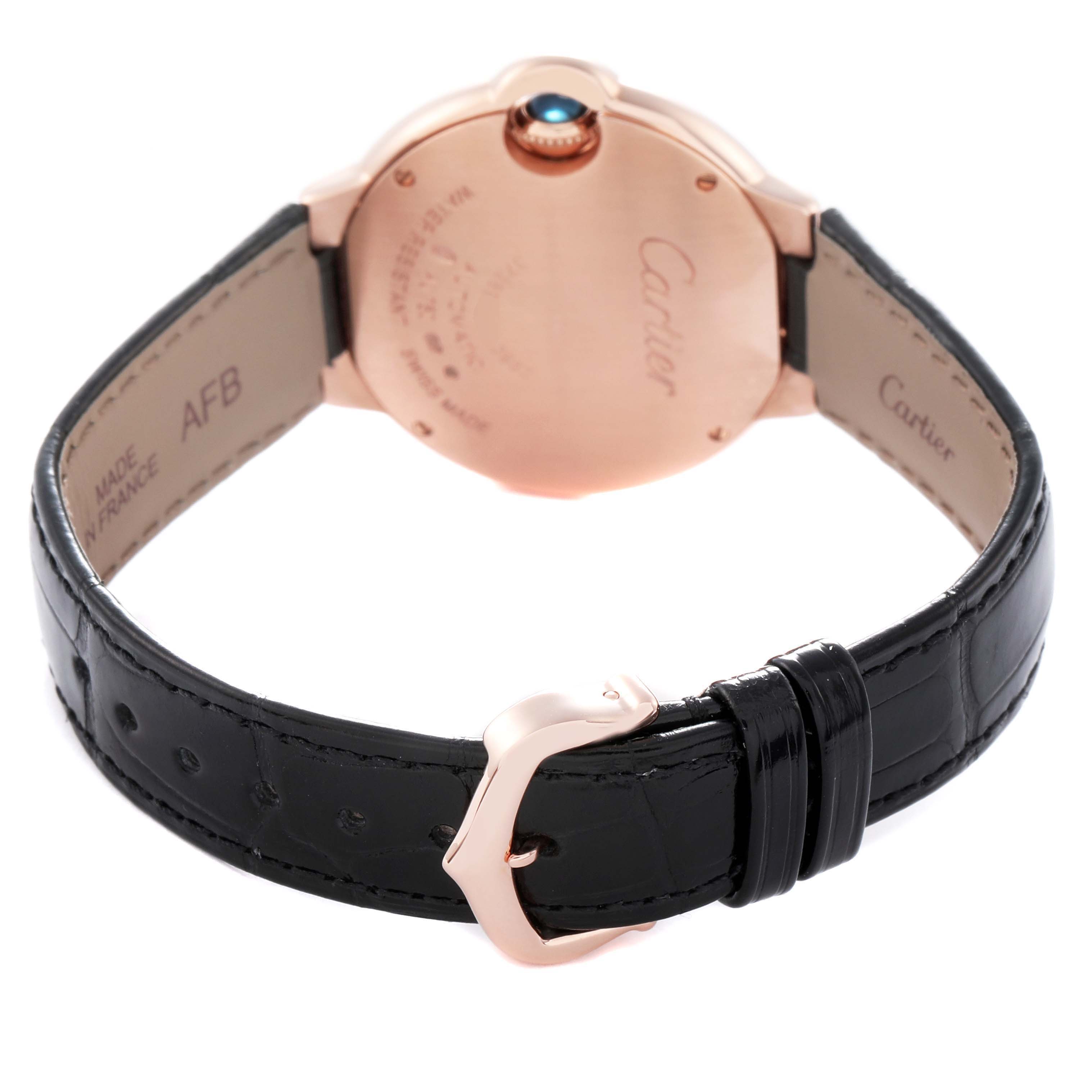 The image shows the back of a Cartier Ballon Bleu WE902066 Women
s Rose Gold Silver Dial WE902066 Women
s Rose Gold Silver Dial watch, featuring the case back, strap, buckle, and crown at an angle.