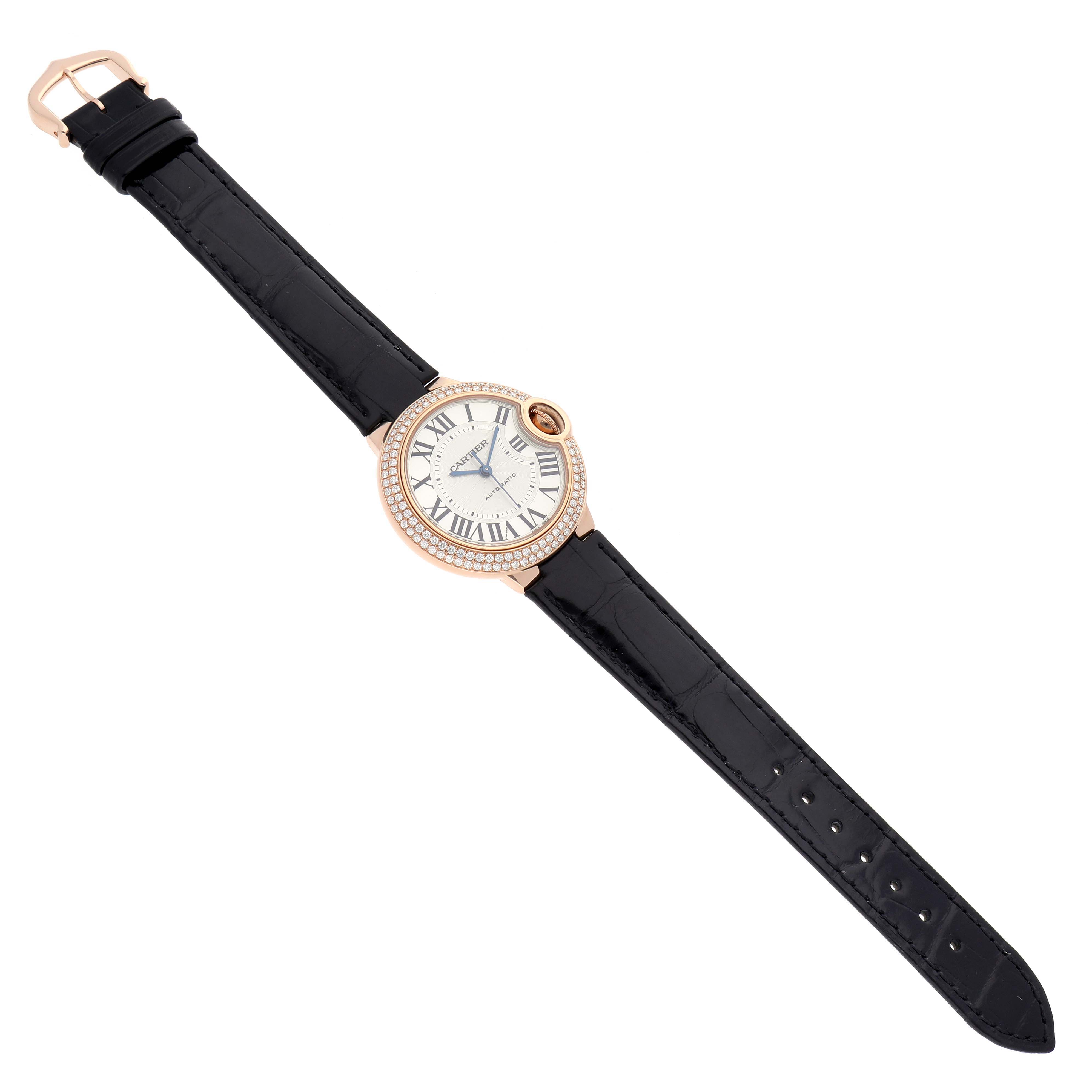 The Cartier Ballon Bleu WE902066 Women
s Rose Gold Silver Dial WE902066 Women
s Rose Gold Silver Dial watch is shown from a top-down angle, displaying the full face, strap, and buckle.