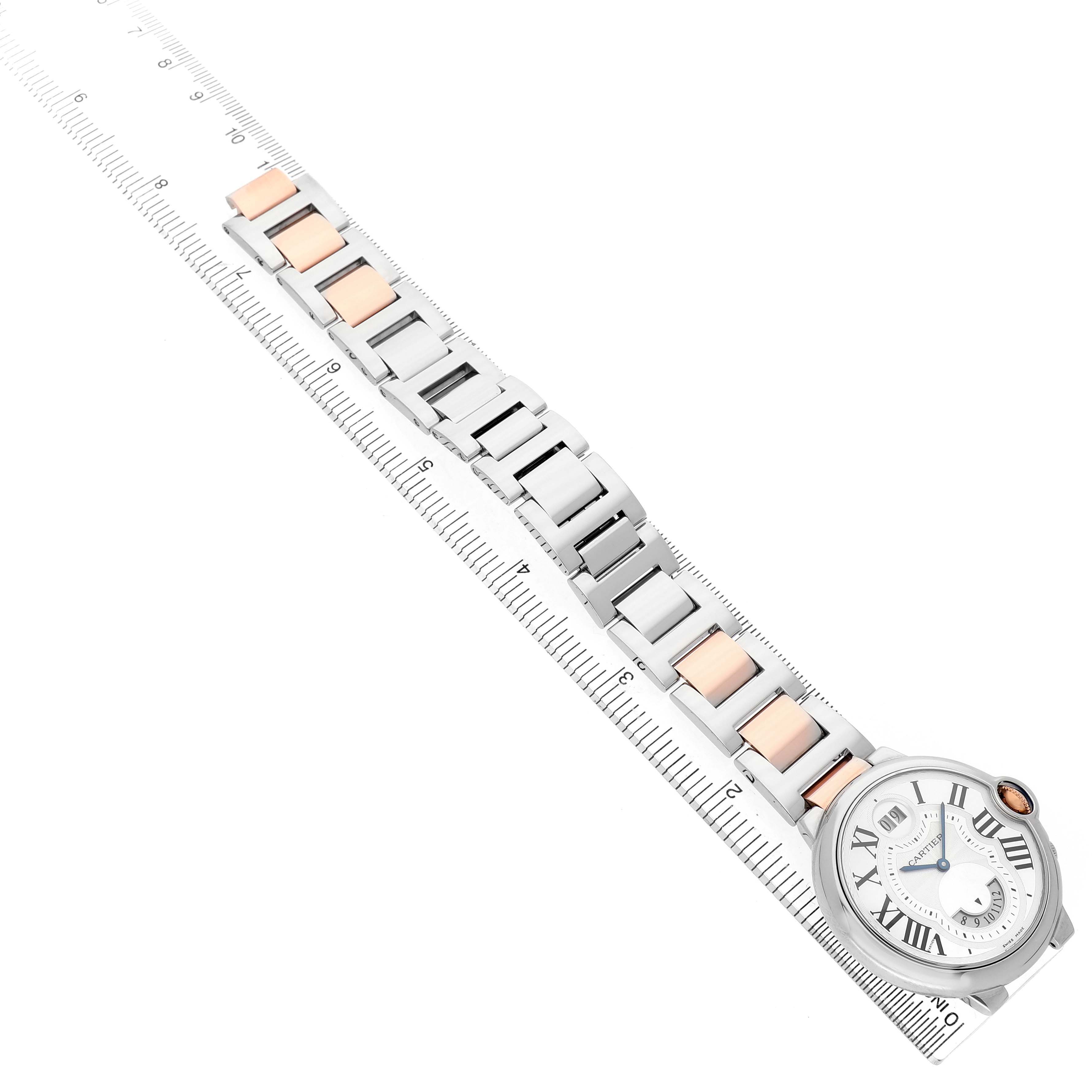 The image shows the front view of a Cartier Ballon Bleu W6920027 Men's Stainless Steel Silver Dial watch with a detailed view of the metal bracelet against a ruler.