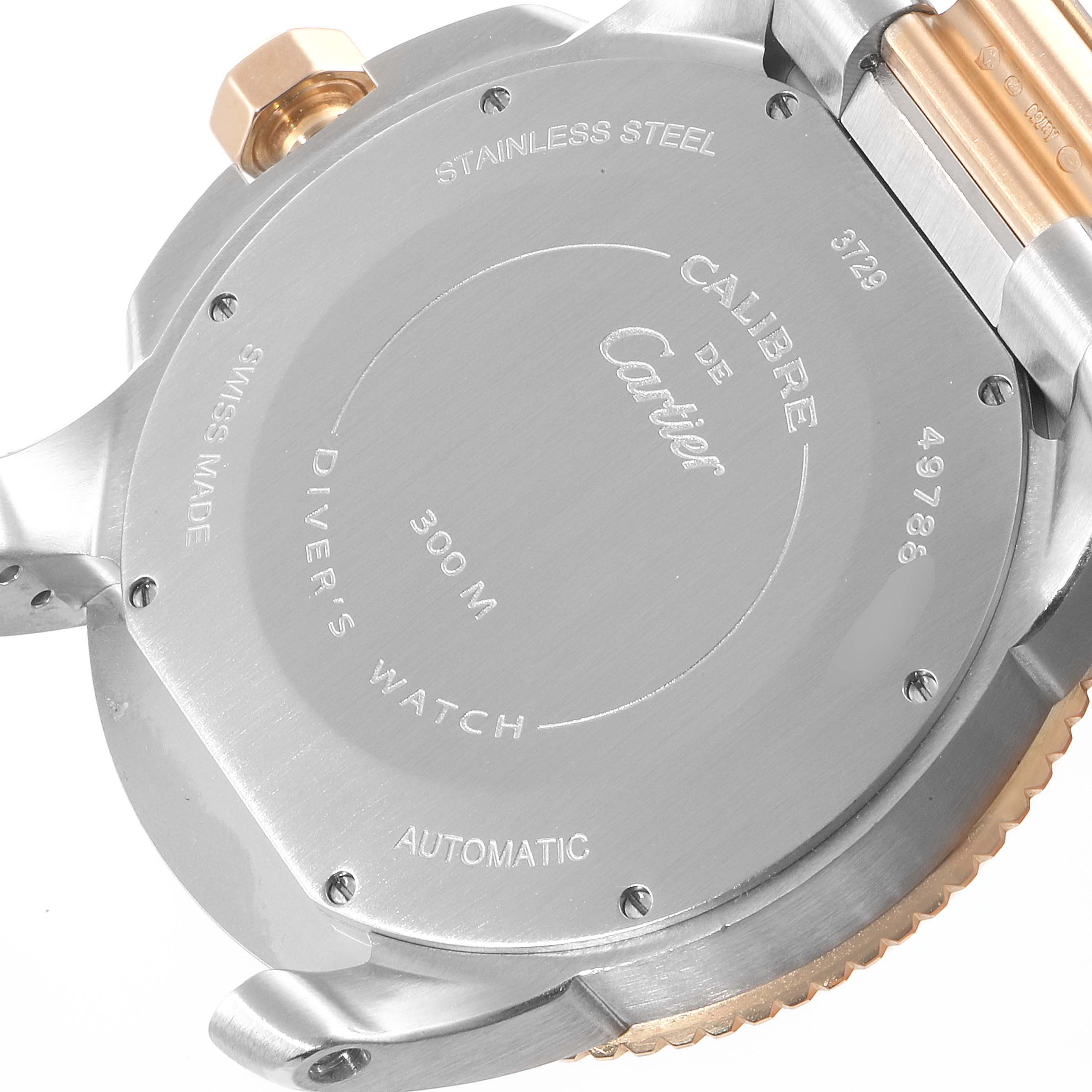 The image shows the back case of a Calibre de Cartier watch by Cartier, highlighting its stainless steel case and engravings.