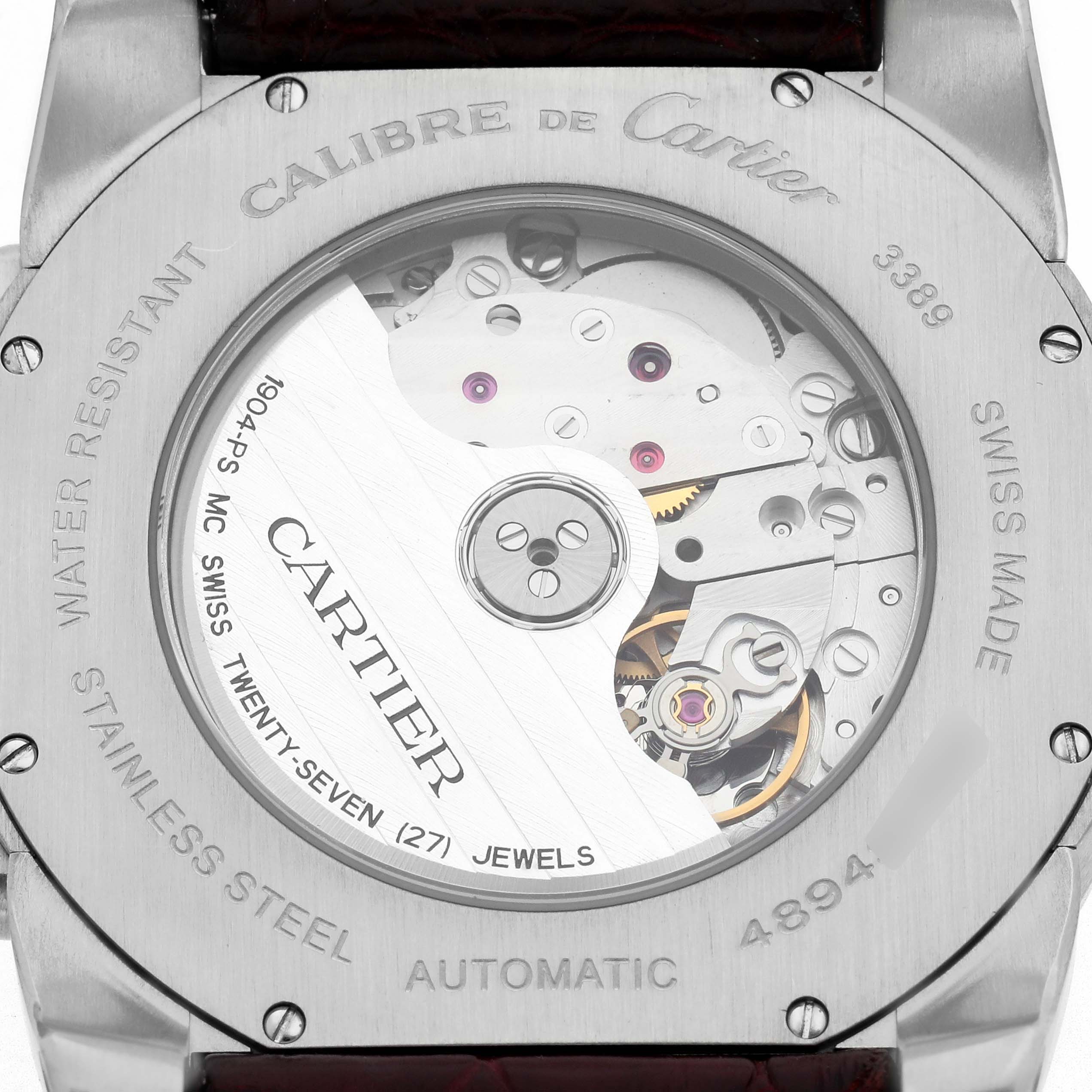 The image shows the back of a Calibre de Cartier watch by Cartier, highlighting its automatic movement and inner mechanisms.