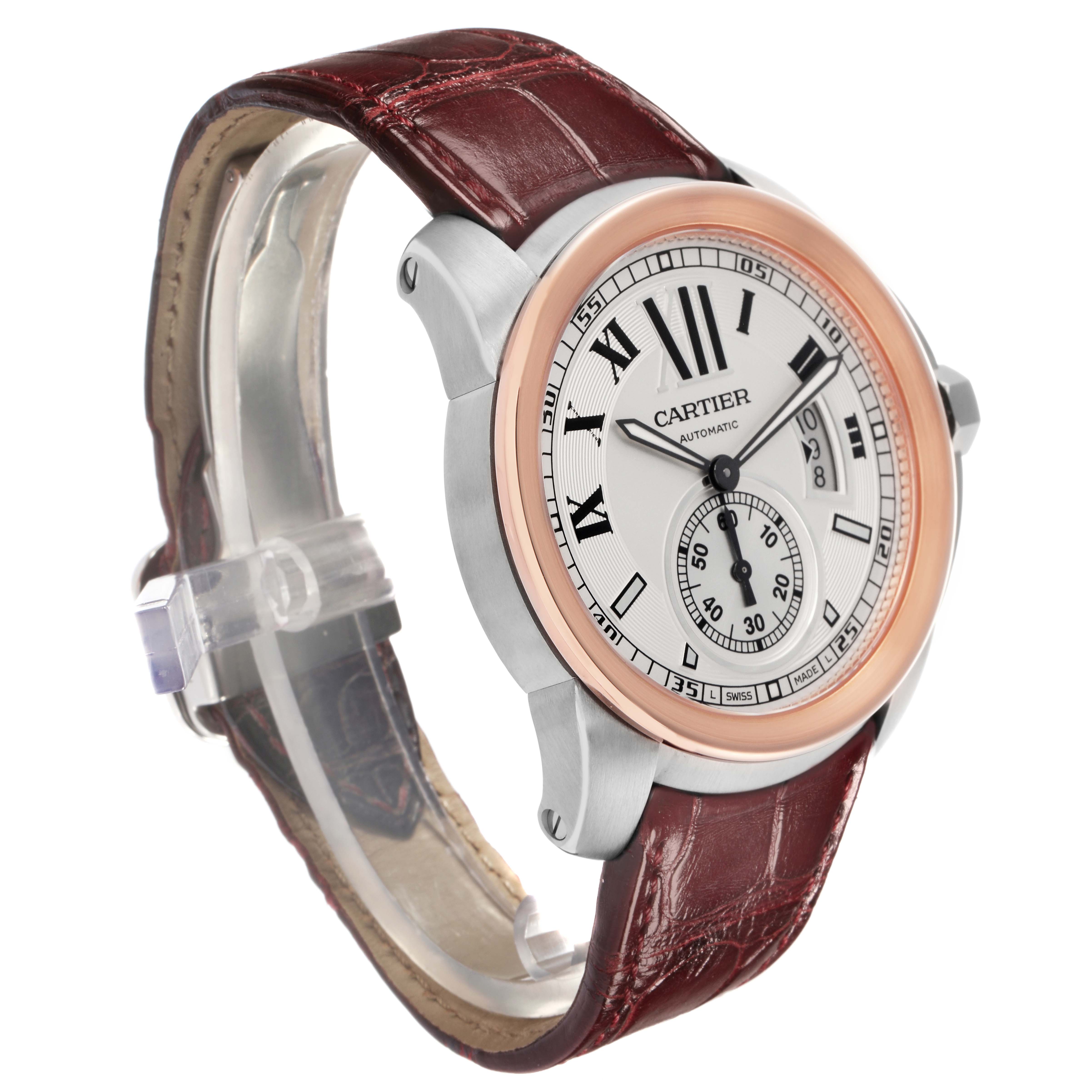 The Calibre de Cartier watch is shown at a slight angle, highlighting the face, bezel, crown, and leather strap.