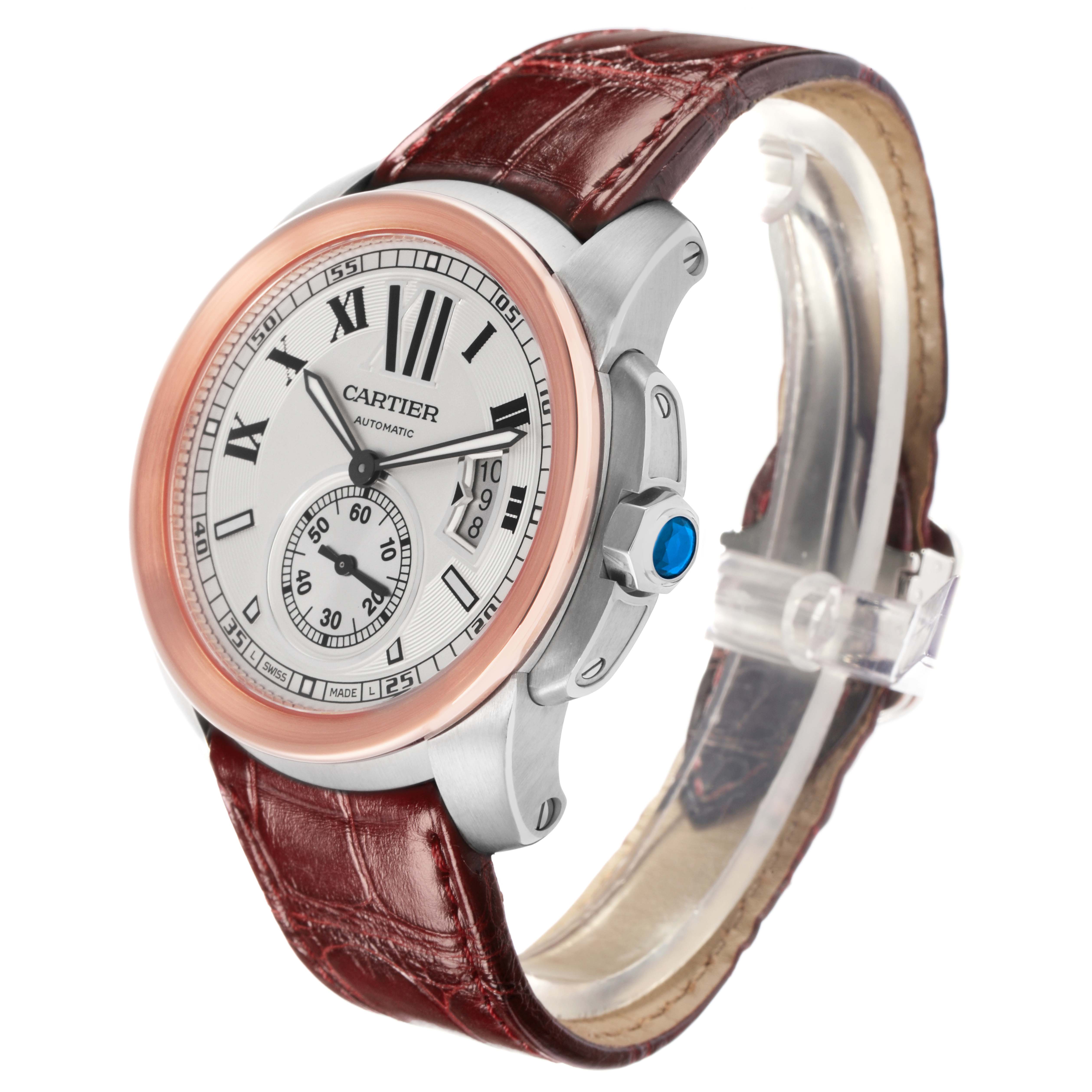 The Calibre de Cartier watch by Cartier is shown at a three-quarter angle, displaying the face, bezel, and brown leather strap.