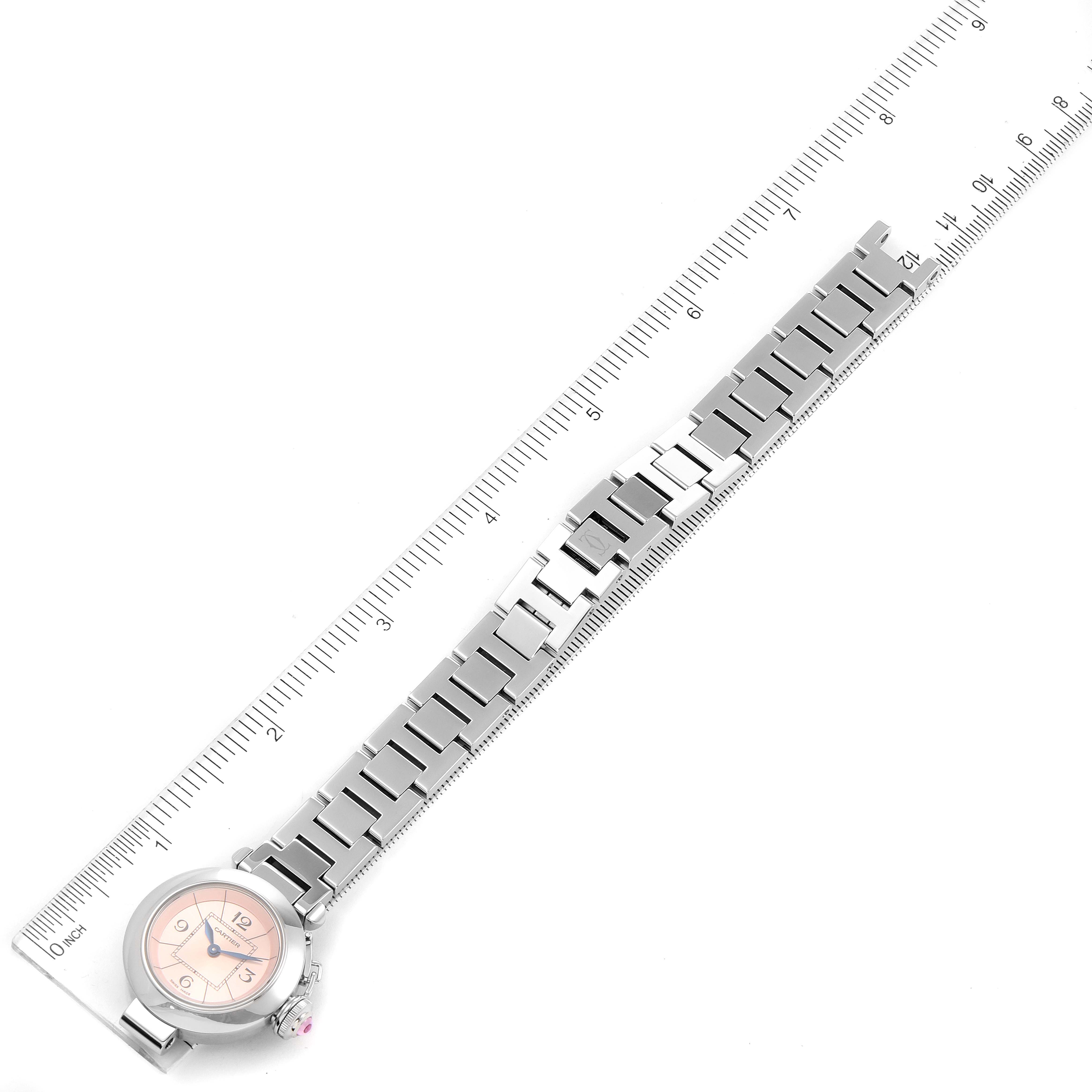 The Cartier Pasha W3140008 Women's Stainless Steel Pink Dial W3140008 Women's Stainless Steel Pink Dial watch is shown in a top-down view, highlighting the face and full metal bracelet next to a ruler.