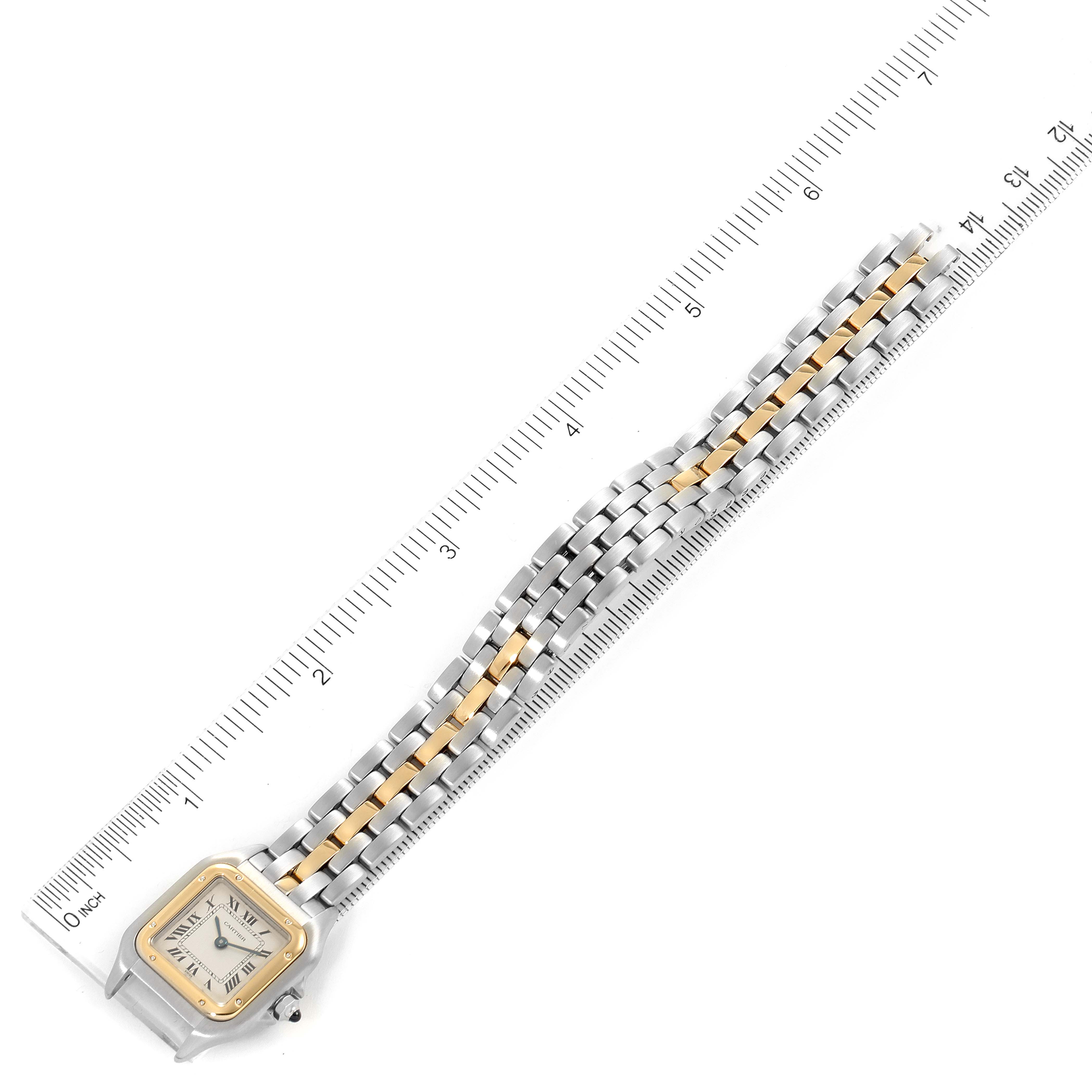 The image shows a Panthere model by Cartier watch from a top-down angle, highlighting the face and bracelet next to a ruler.