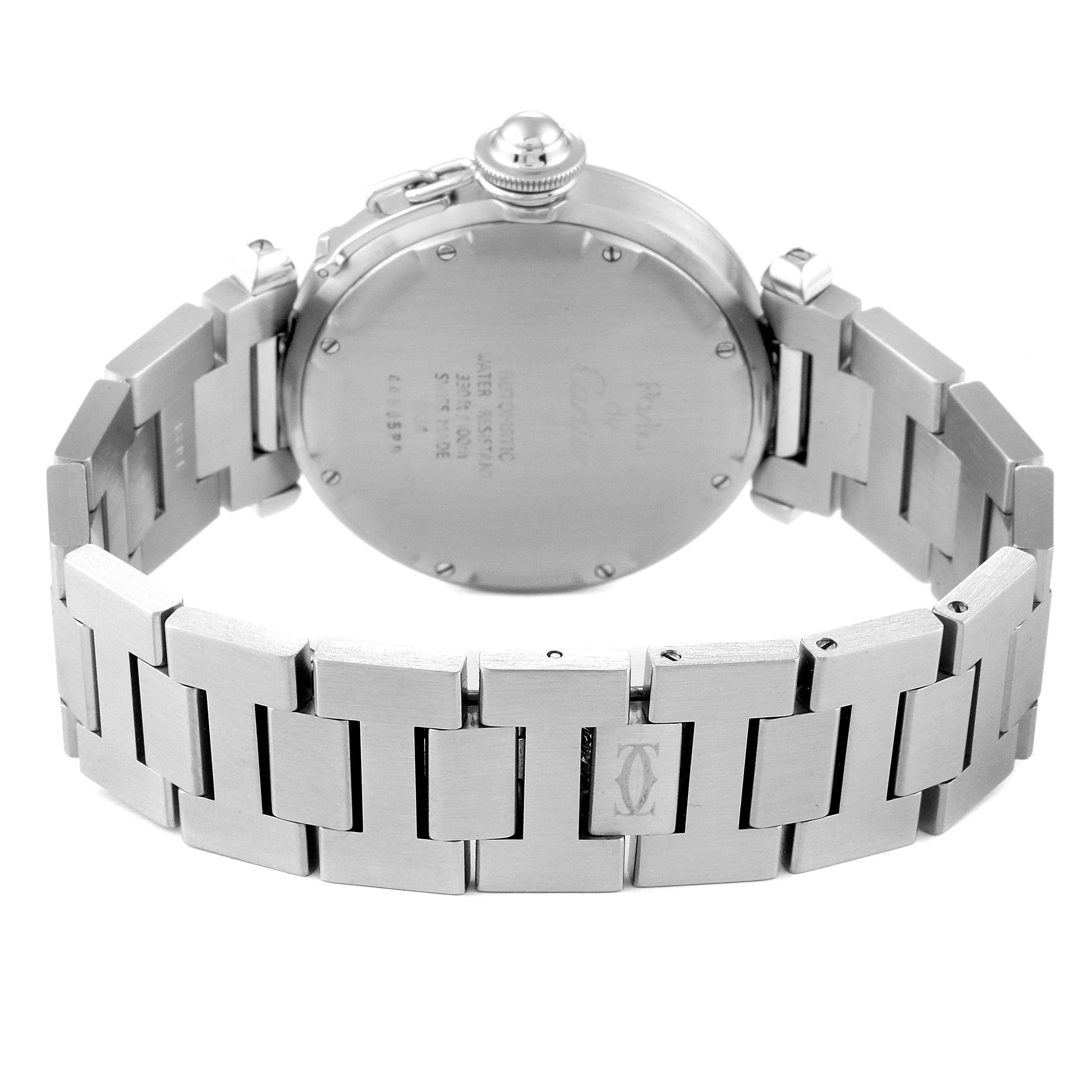 The image shows the back view of a Pasha model watch by Cartier, highlighting its stainless steel bracelet and case back.