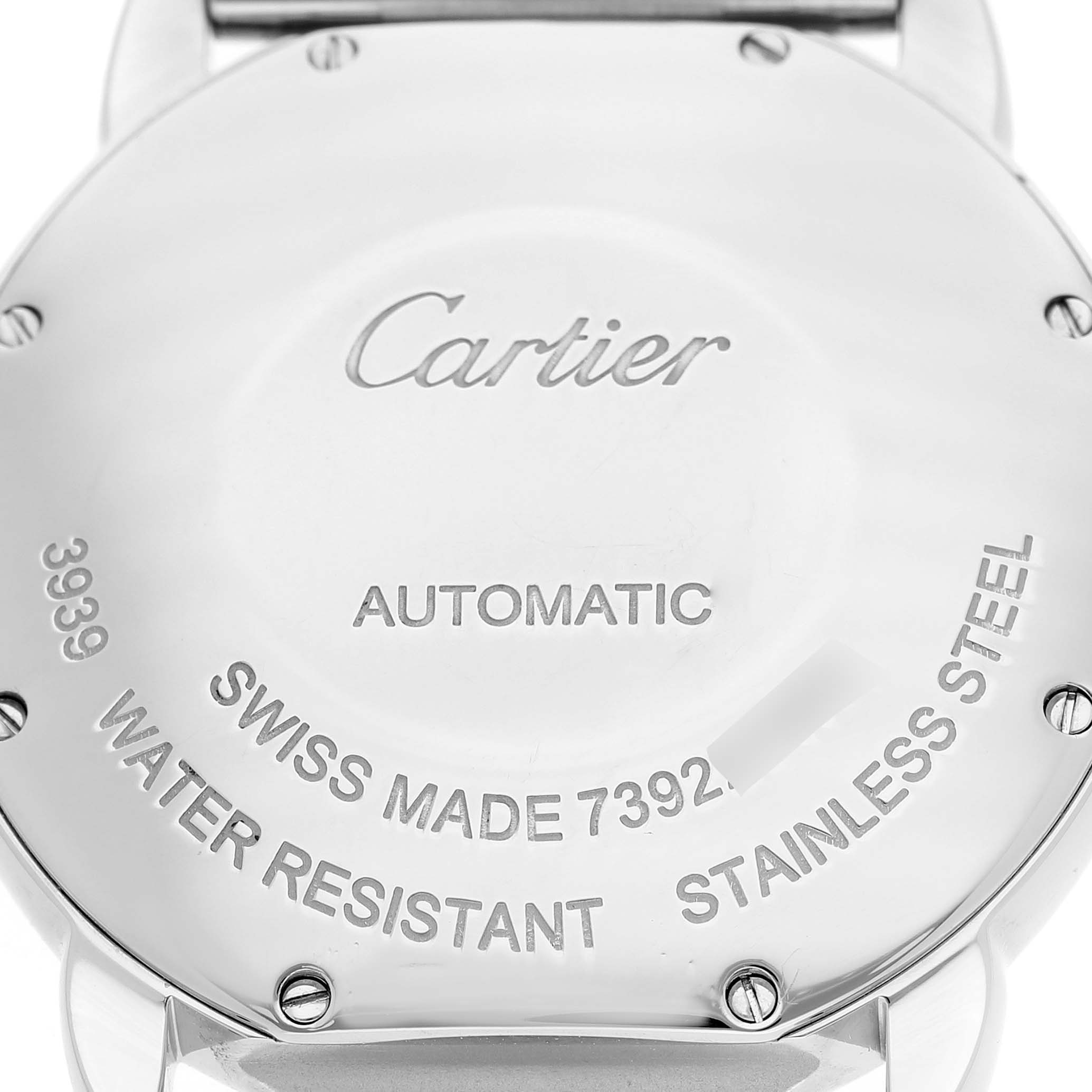 The image shows the back case of the Cartier Ronde WSRN0012 Men's Stainless Steel Silver Dial watch, highlighting its brand, automatic movement, and material specifications.
