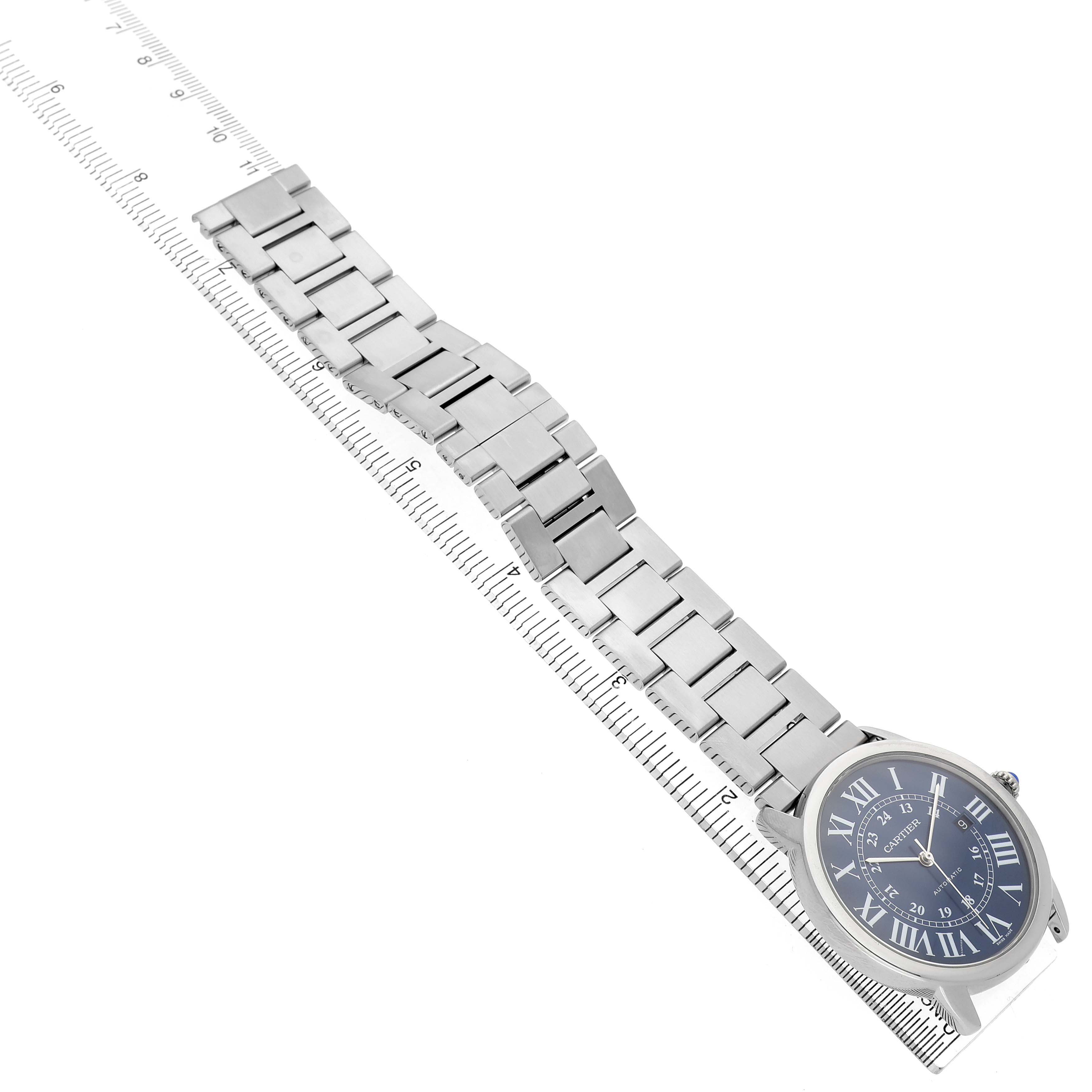 The Cartier Ronde WSRN0023 Men's Stainless Steel Blue Dial watch is shown from an angled top view, highlighting its metal bracelet and round face.