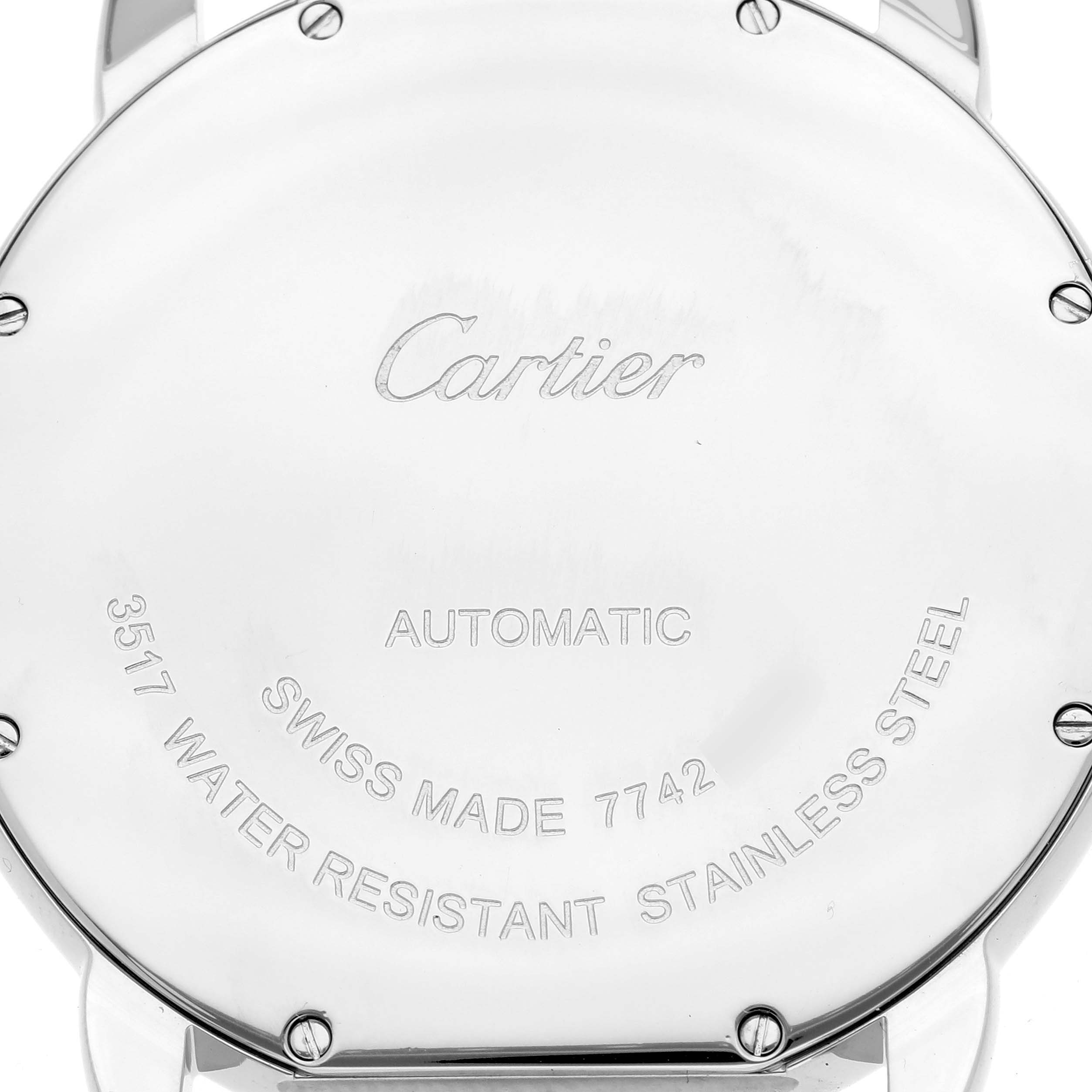 The image shows the back of a Cartier Ronde W6701011 Men's Stainless Steel Silver Dial W6701011 Men's Stainless Steel Silver Dial model watch, featuring engravings and screws.
