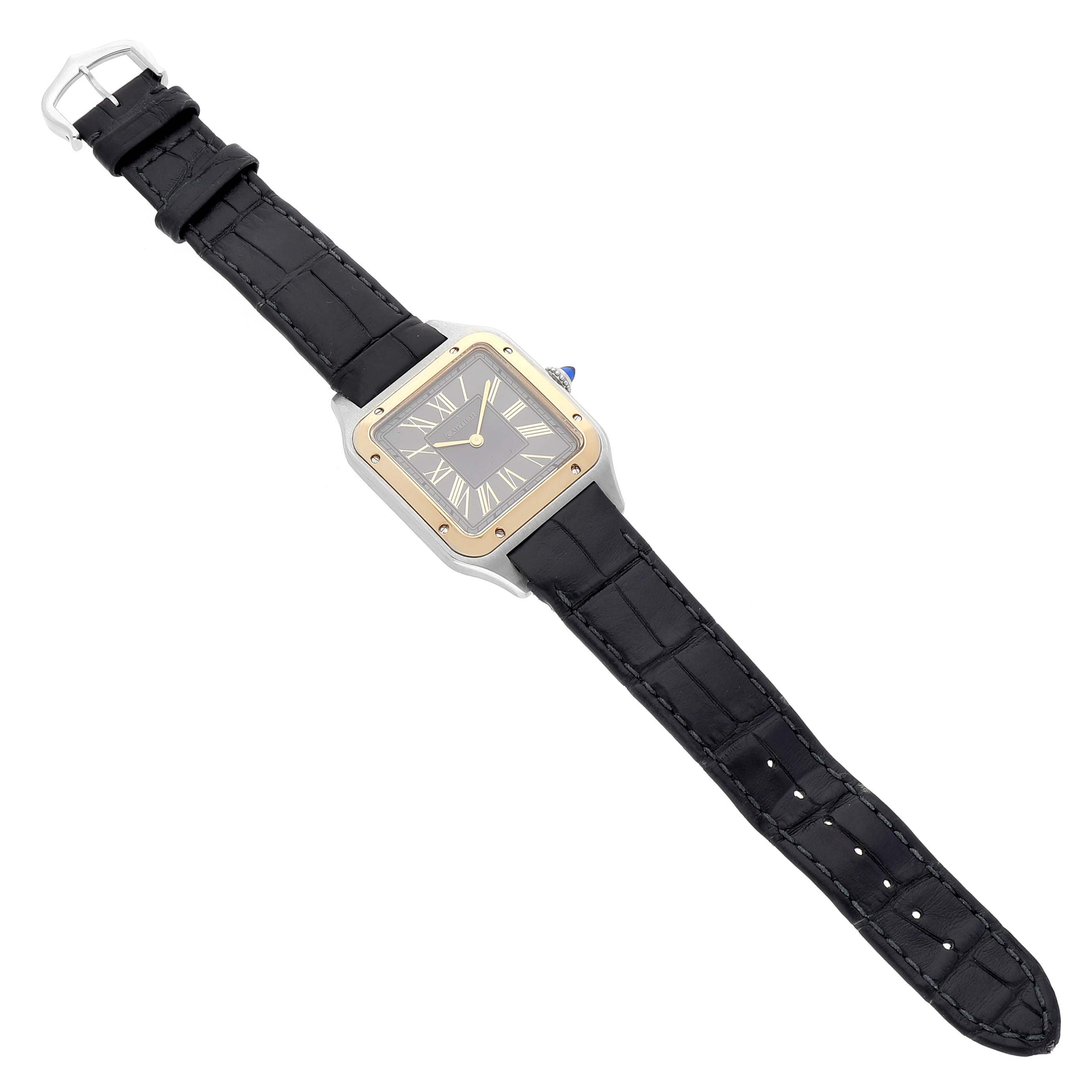 The Cartier Santos Dumont W2SA0028 Men's Steel and Gold (two tone) Grey Dial watch is shown from a top-down angle, displaying its face, bezel, and black strap.