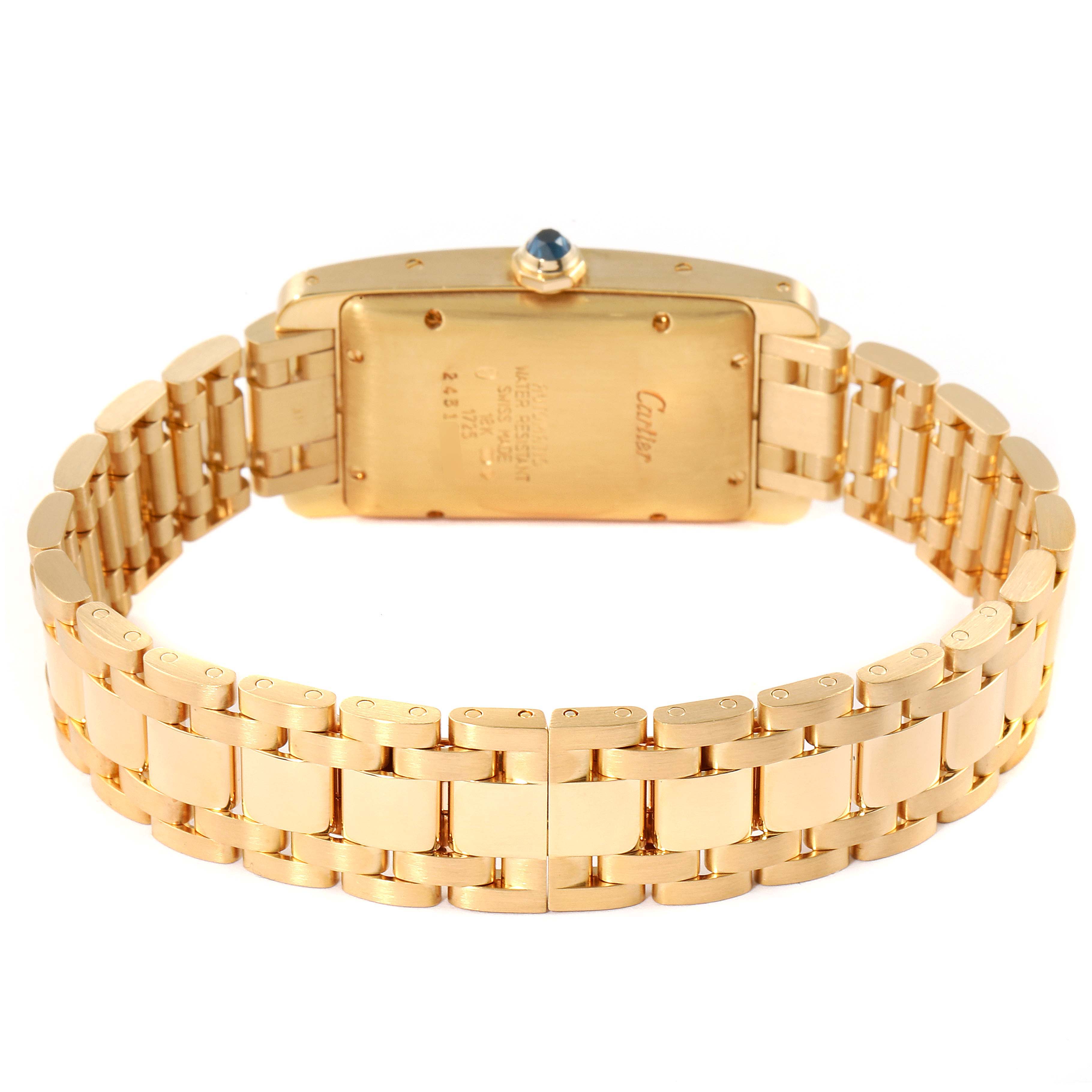 The image shows the reverse side of a Cartier Tank Americaine W26035K2 Women's Yellow Gold Silver Dial W26035K2 Women's Yellow Gold Silver Dial watch, focusing on the gold bracelet and case back.