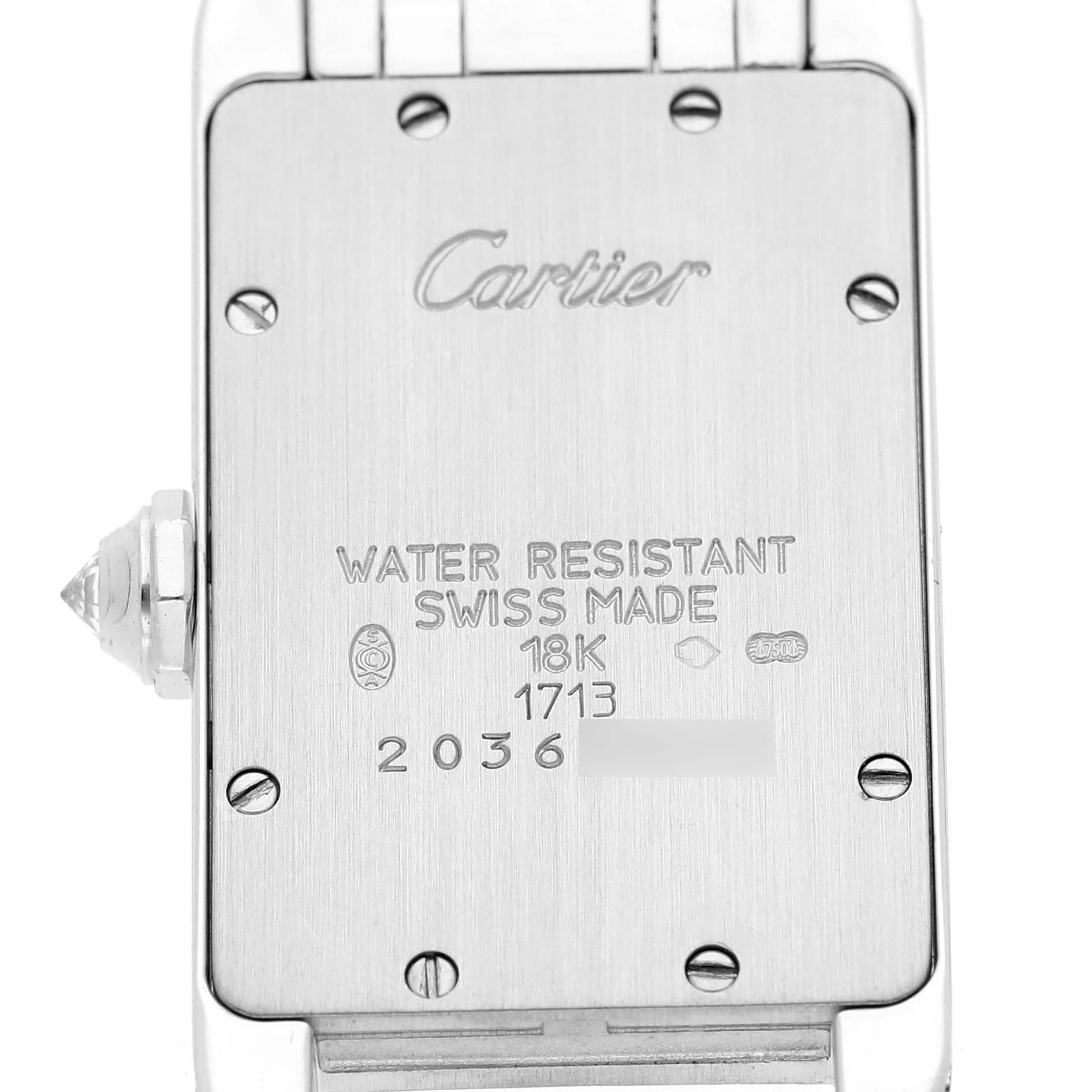 This image shows the back case of a Cartier Tank Americaine WB7018L1 Women's White Gold Silver Dial WB7018L1 Women's White Gold Silver Dial watch with inscriptions and screws visible.