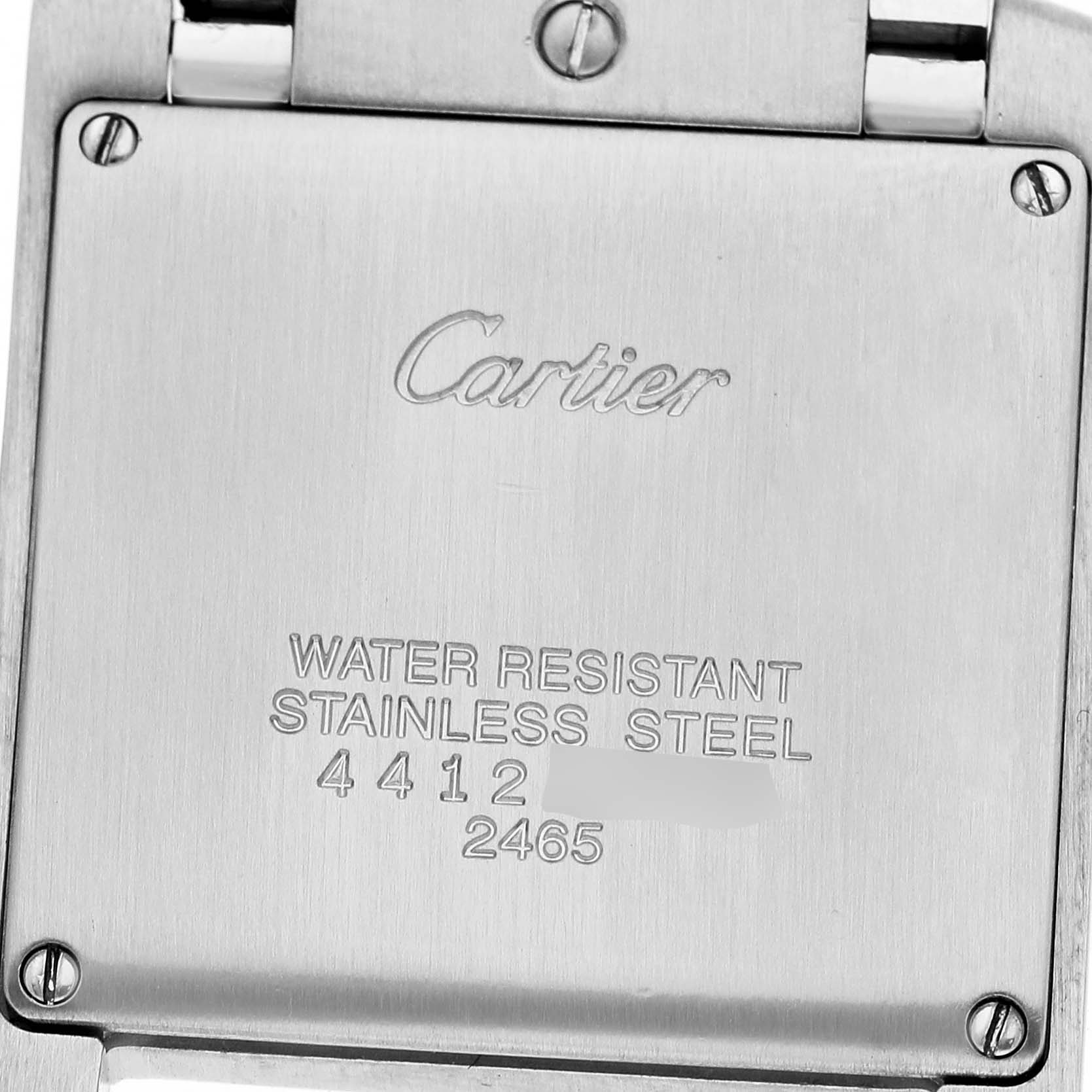 The image shows the back case of a Cartier Tank Francaise W51011Q3 Women's Stainless Steel Silver Dial watch, displaying engraved text and screws.