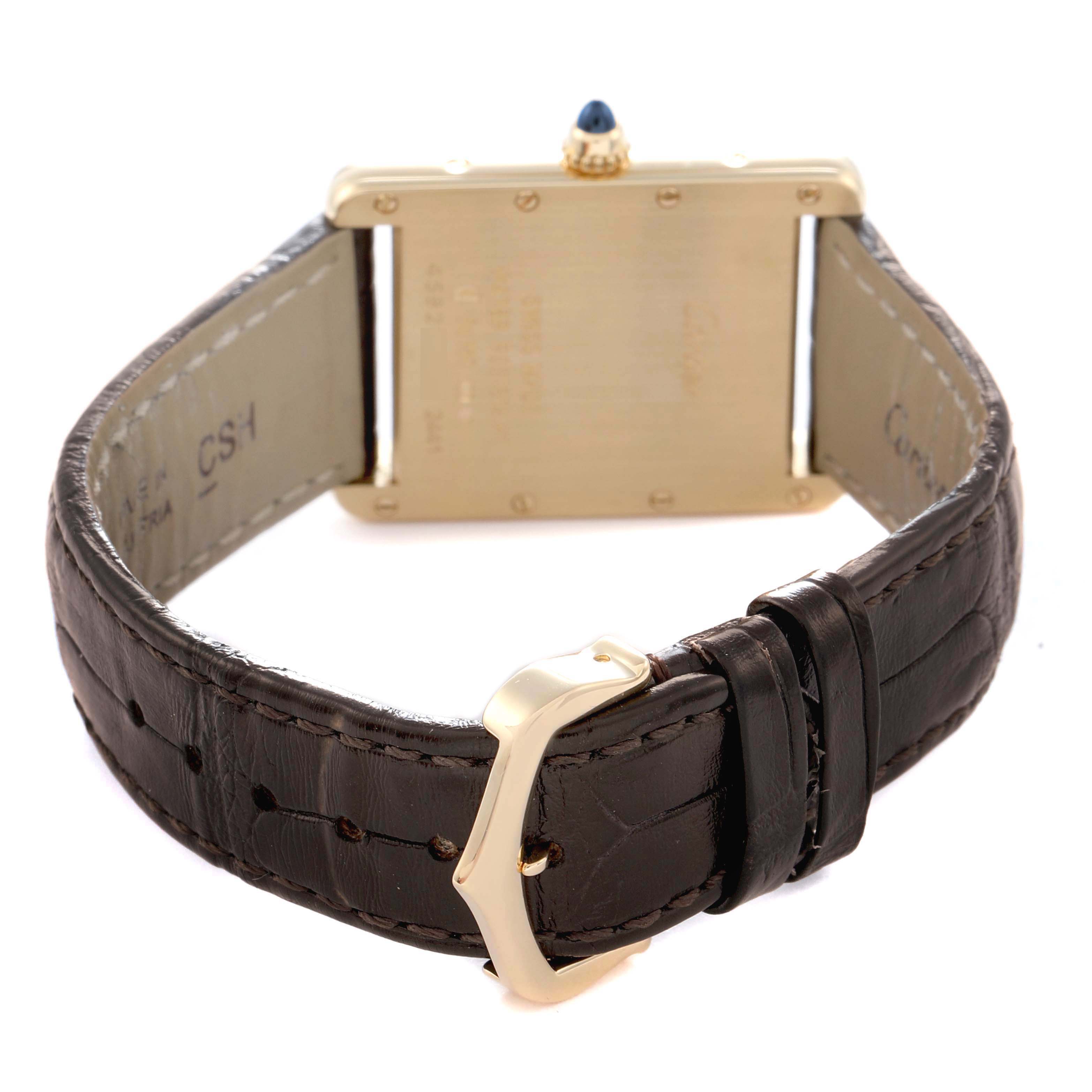 The image shows the back of a Cartier Tank Louis W1529756 Men
s Yellow Gold Silver Dial W1529756 Men
s Yellow Gold Silver Dial watch, focusing on the case, a blue cabochon crown, and brown leather strap with buckle.
