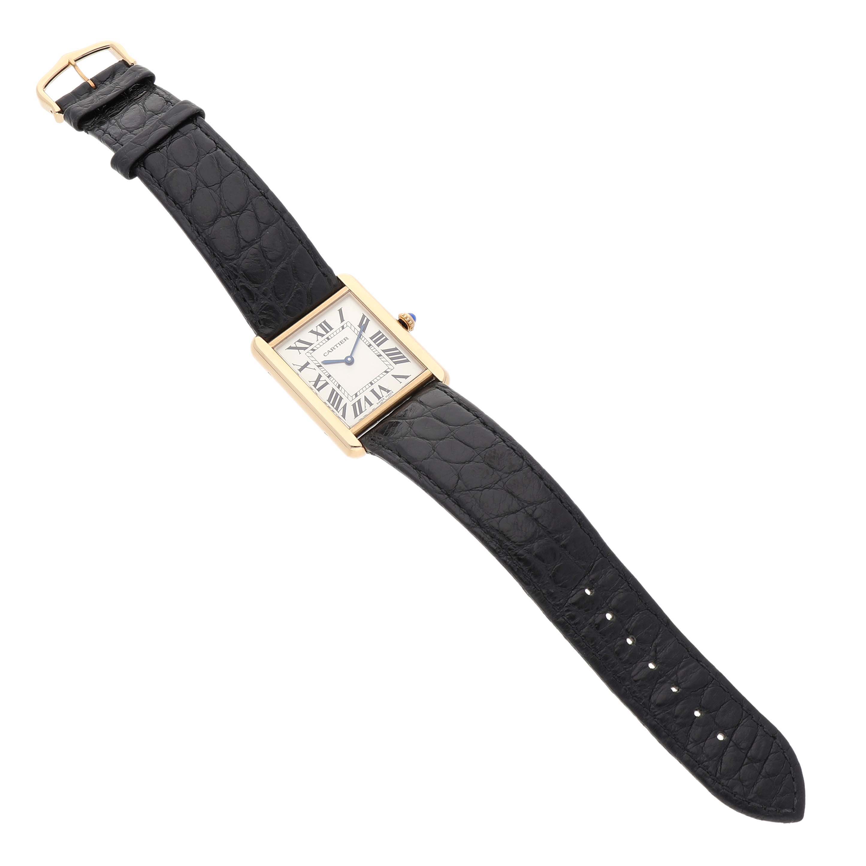 The Cartier Tank Solo W5200004 Men's Yellow Gold Silver Dial watch is shown at an angled top view, displaying its face, strap, and buckle clasp.