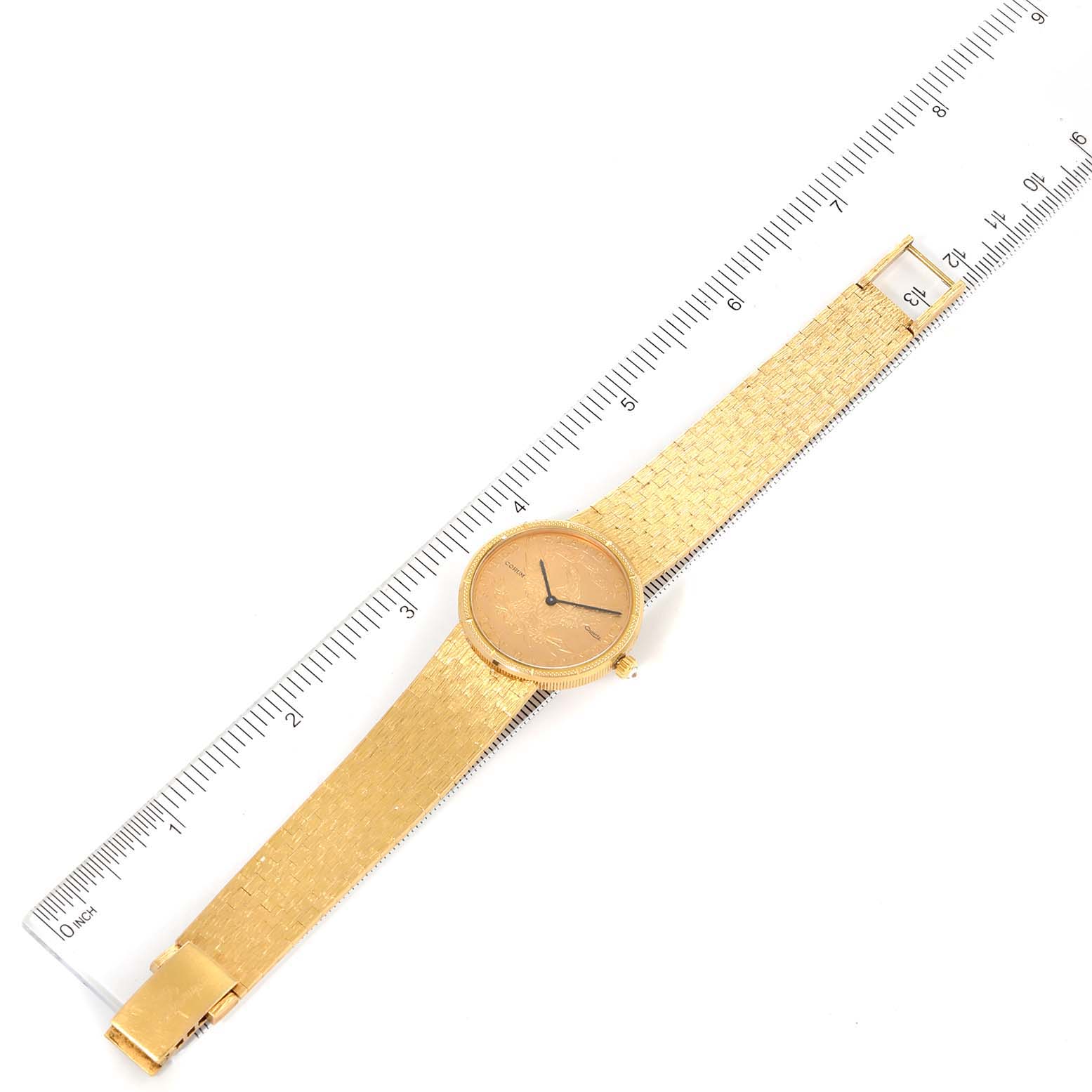 The Coin 10 Dollars Eagle Yellow Gold Ladies Watch 1901 by Corum 1901 Women's Yellow Gold Black Dial 1901 Women's Yellow Gold Black Dial is shown from a top-down angle with a ruler for scale.
