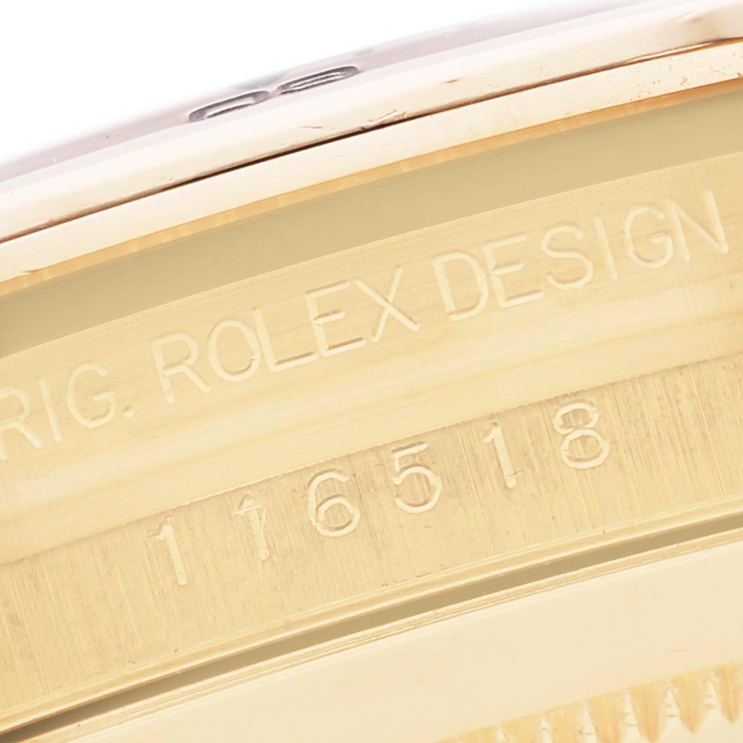 The image shows a close-up of the side of the bezel of a Rolex Daytona 116518 Men
s Yellow Gold Mother of Pearl Dial 116518 Men
s Yellow Gold Mother of Pearl Dial, highlighting the engraved model number.