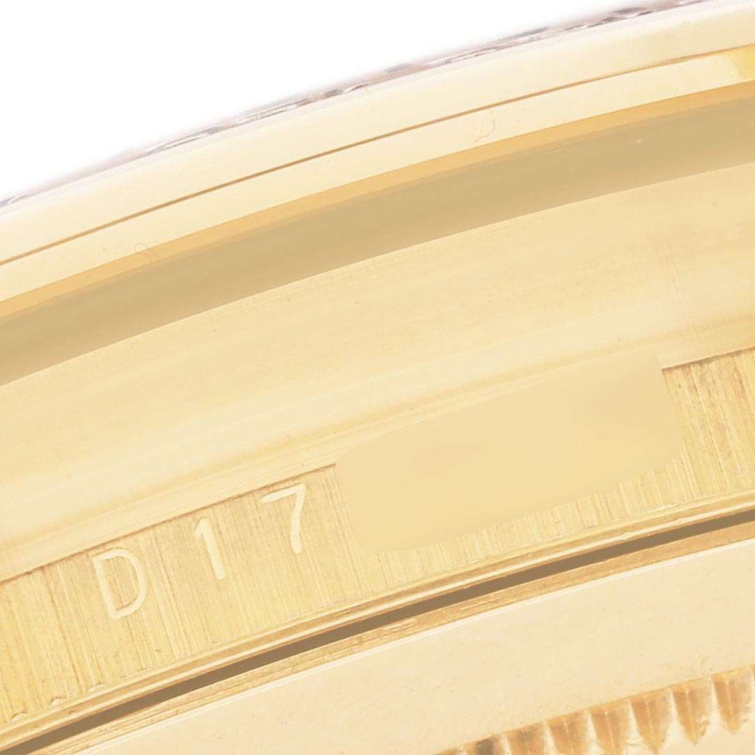 The image shows a close-up of the side of a Rolex Daytona 116518 Men
s Yellow Gold Mother of Pearl Dial 116518 Men
s Yellow Gold Mother of Pearl Dial, focusing on the edge of the case with part of the serial number visible.