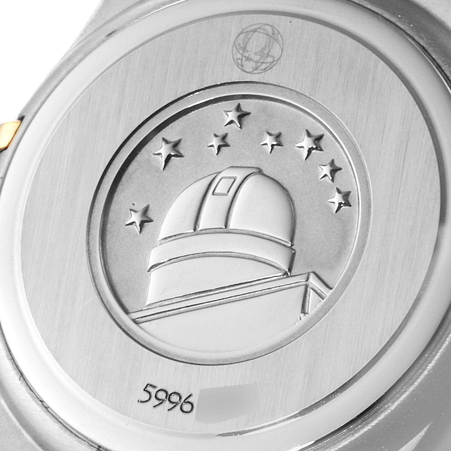 This image shows the case back of the Omega 1267.75.00 Women
s Steel and Gold (two tone) Mother of Pearl Dial 1267.75.00 Women
s Steel and Gold (two tone) Mother of Pearl Dial Constellation 95 Mother of Pearl Diamond Watch 1267.75.00, including its emblem and serial number.