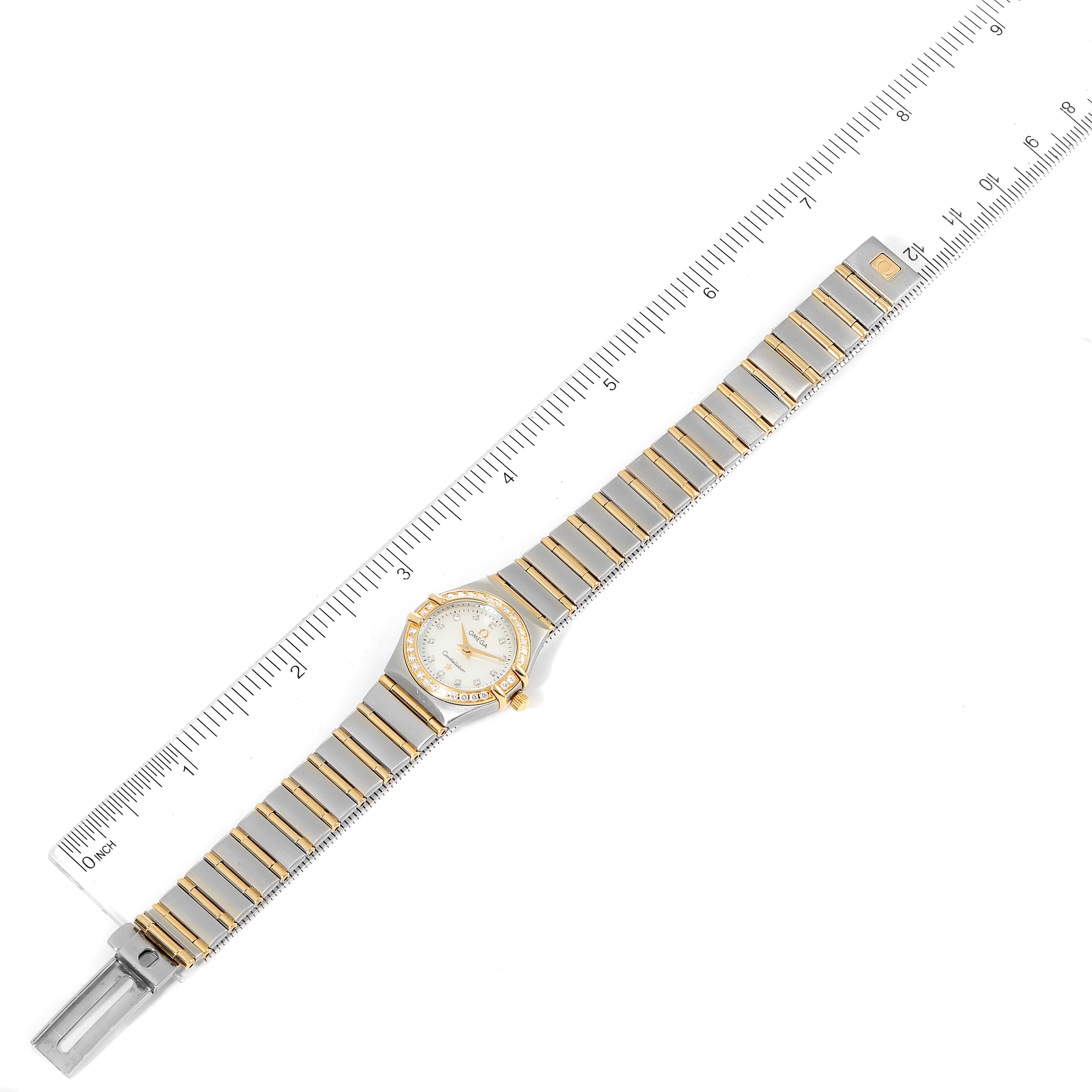 The Omega 1267.75.00 Women
s Steel and Gold (two tone) Mother of Pearl Dial 1267.75.00 Women
s Steel and Gold (two tone) Mother of Pearl Dial Constellation 95 Mother of Pearl Diamond Watch 1267.75.00 is shown flat with the face and full bracelet visible, alongside a ruler.