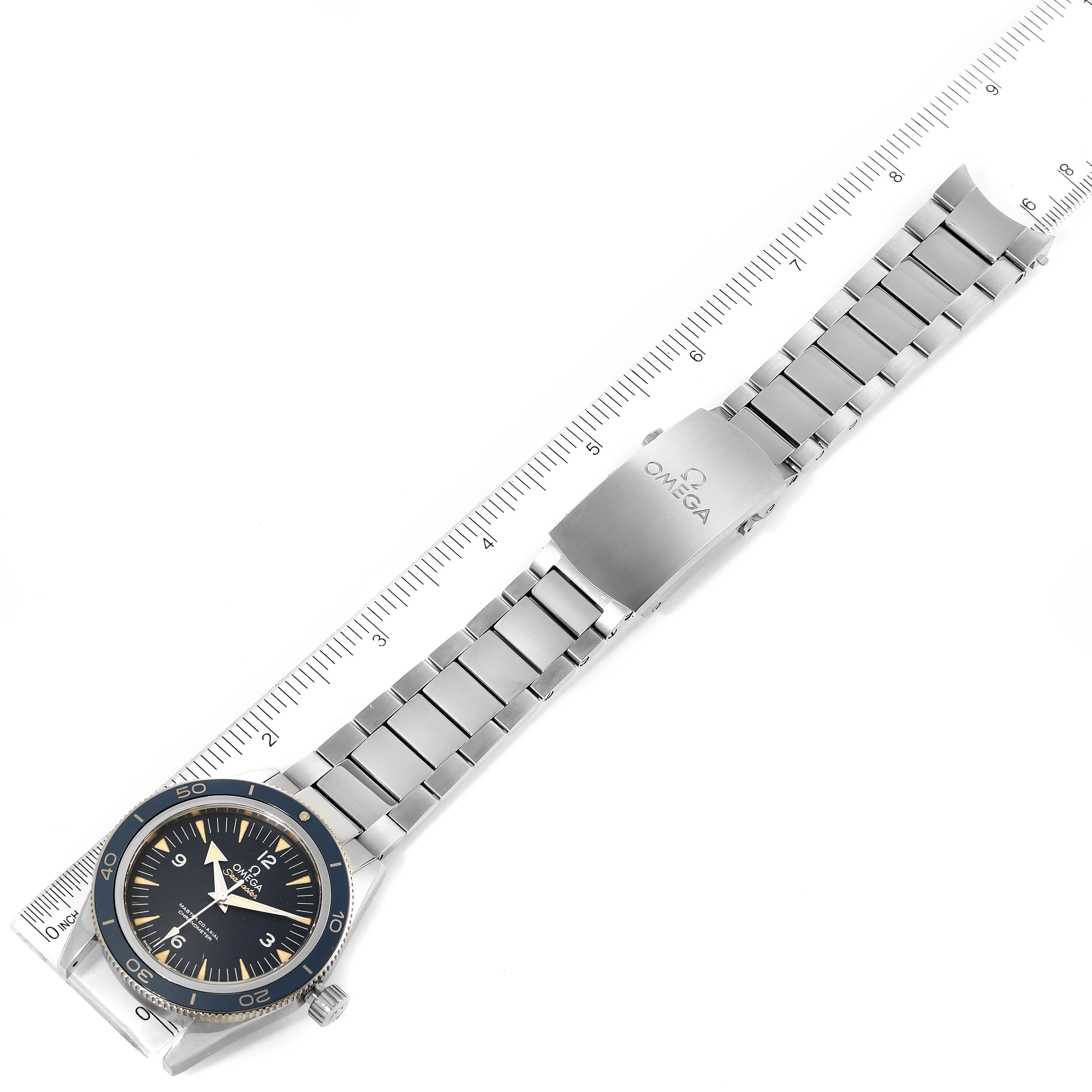 The watch is an Omega Seamaster 233.90.41.21.03.001 Men's Titanium Blue Dial 233.90.41.21.03.001 Men's Titanium Blue Dial model, shown at a top-down angle, displaying the face, metal bracelet, and clasp against a ruler.