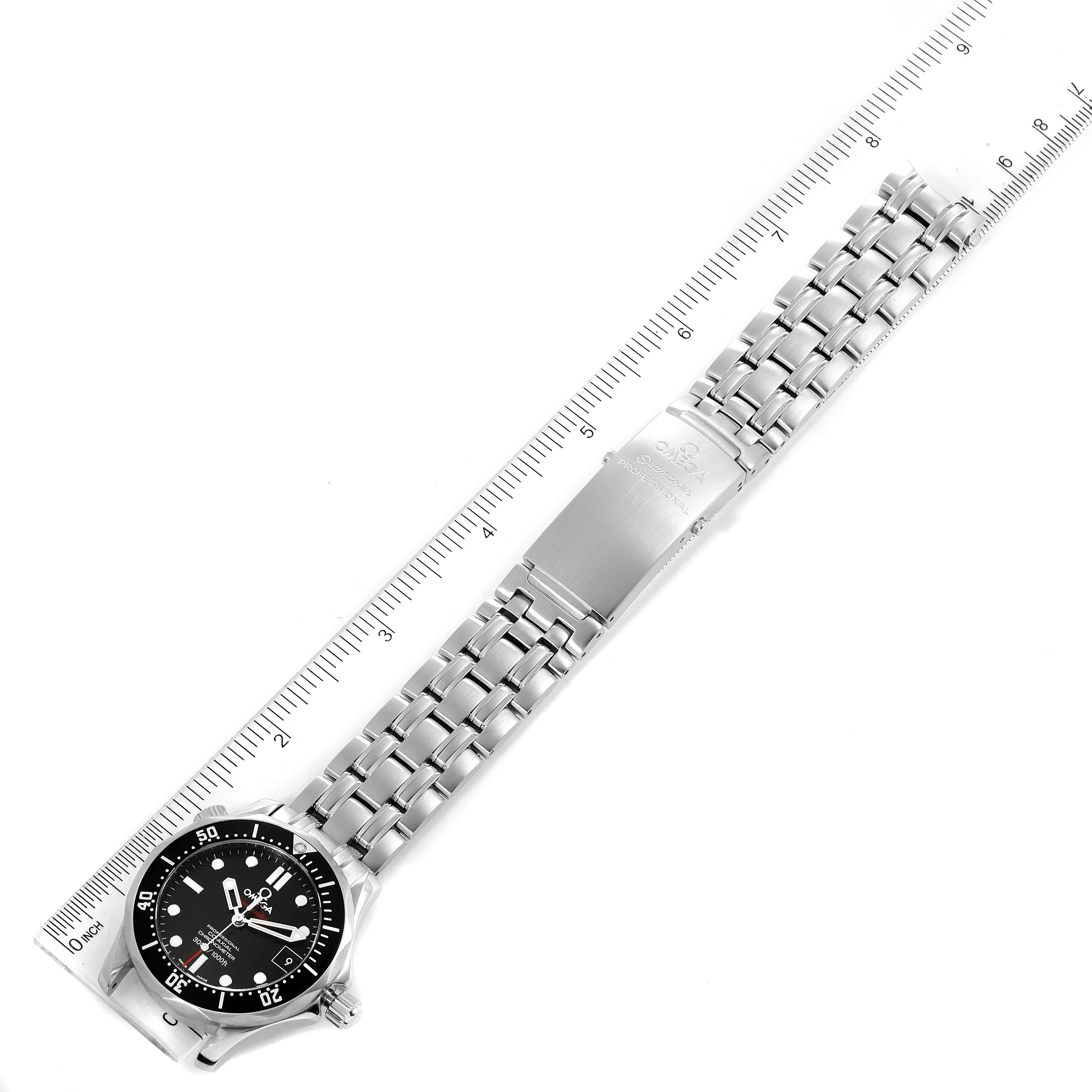 The Omega Seamaster 212.30.36.20.01.001 Men's Stainless Steel Black Dial 212.30.36.20.01.001 Men's Stainless Steel Black Dial watch is shown from a top view, featuring its face, full metal bracelet, and clasp, alongside a ruler for scale.