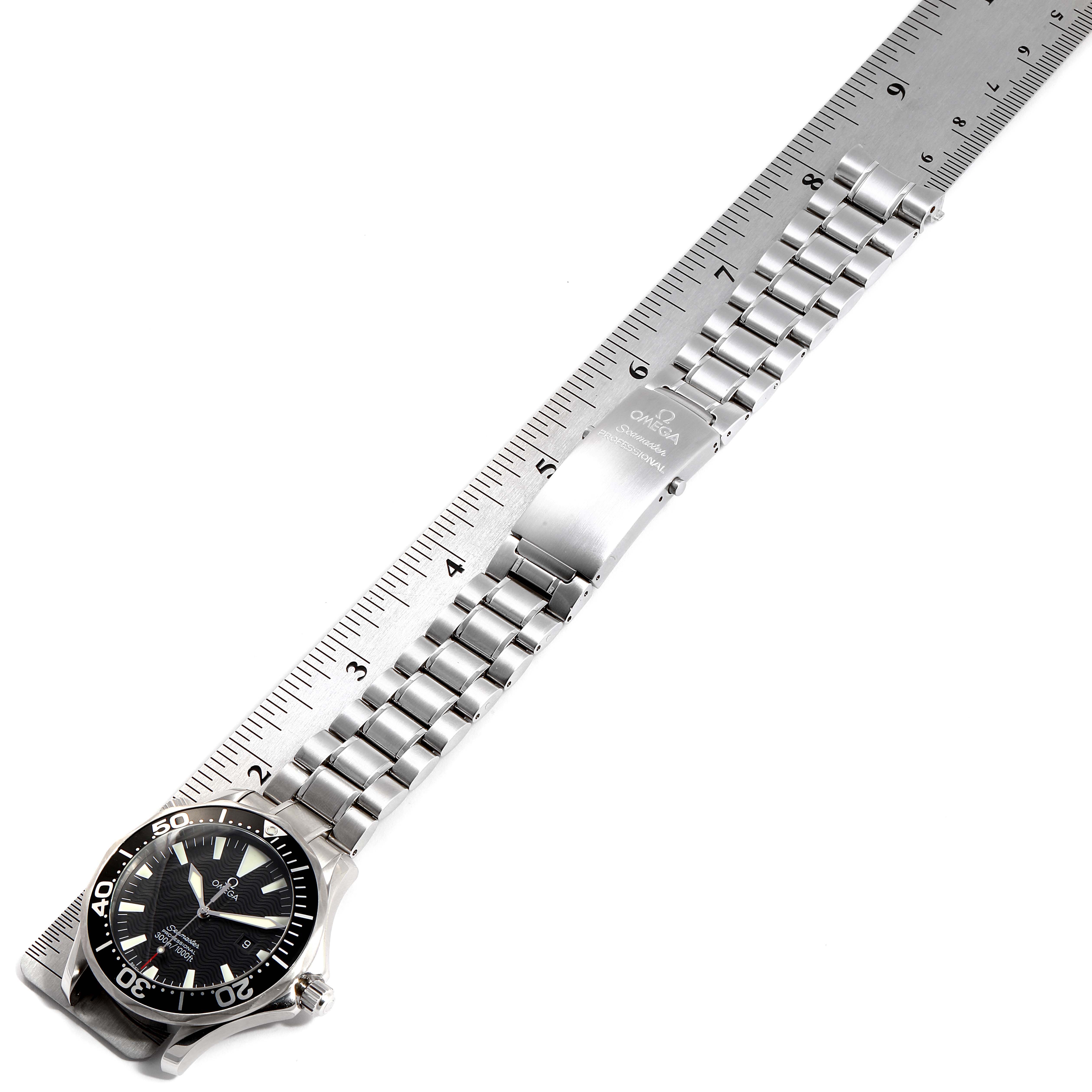 The image displays an Omega Seamaster 2264.50.00 Men
s Stainless Steel Black Dial 2264.50.00 Men
s Stainless Steel Black Dial watch laid flat with the full bracelet and clasp visible alongside a ruler for scale.