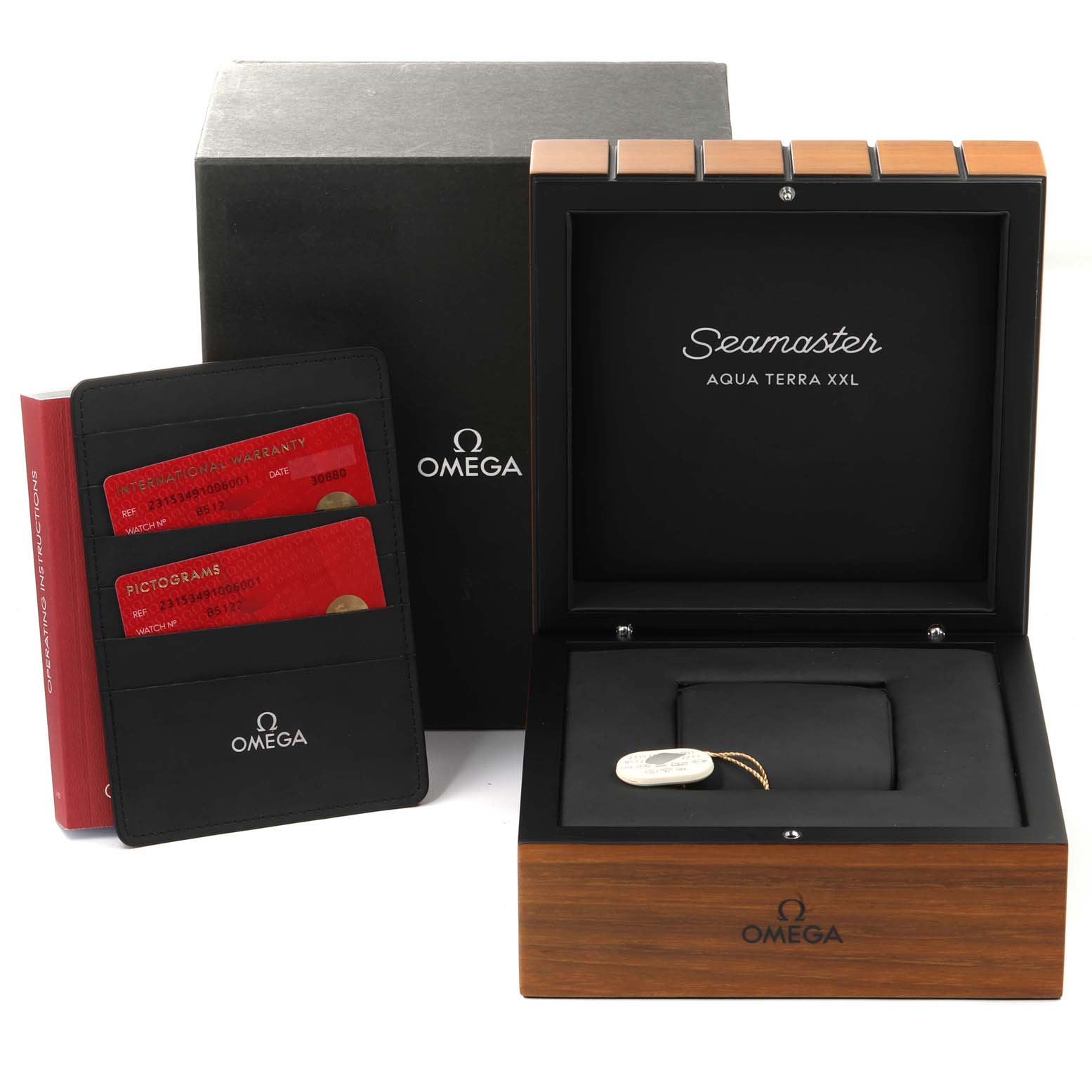The image shows the packaging and accessories for an Omega Seamaster Aqua Terra model, including a box, warranty cardholder, and tags.