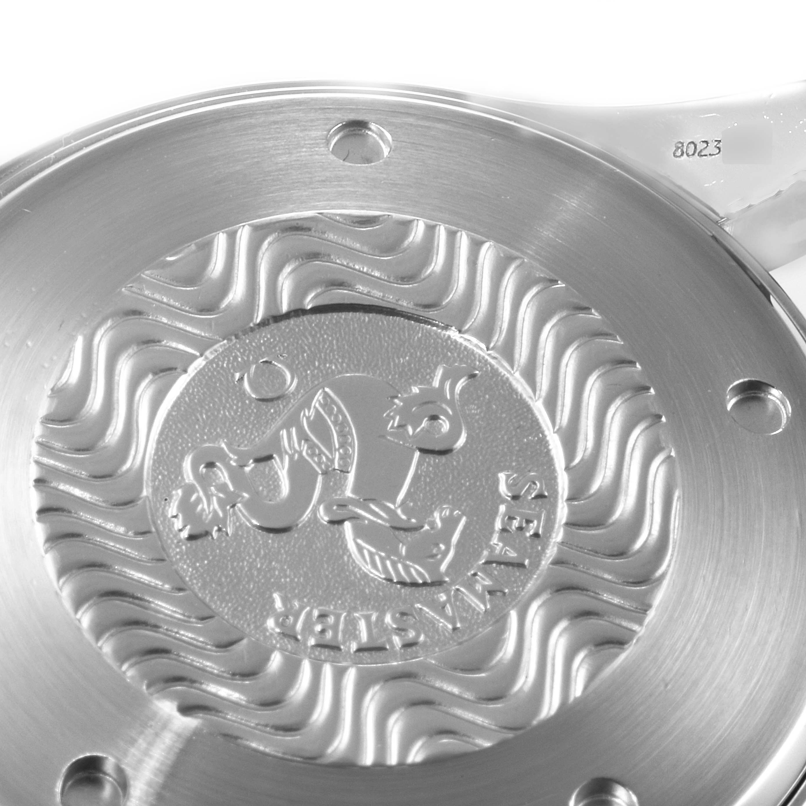 This image shows the rear case back of the Omega Seamaster 2599.80.00 Men
s Stainless Steel Blue Dial 2599.80.00 Men
s Stainless Steel Blue Dial watch, highlighting its engraved design and wave patterns.