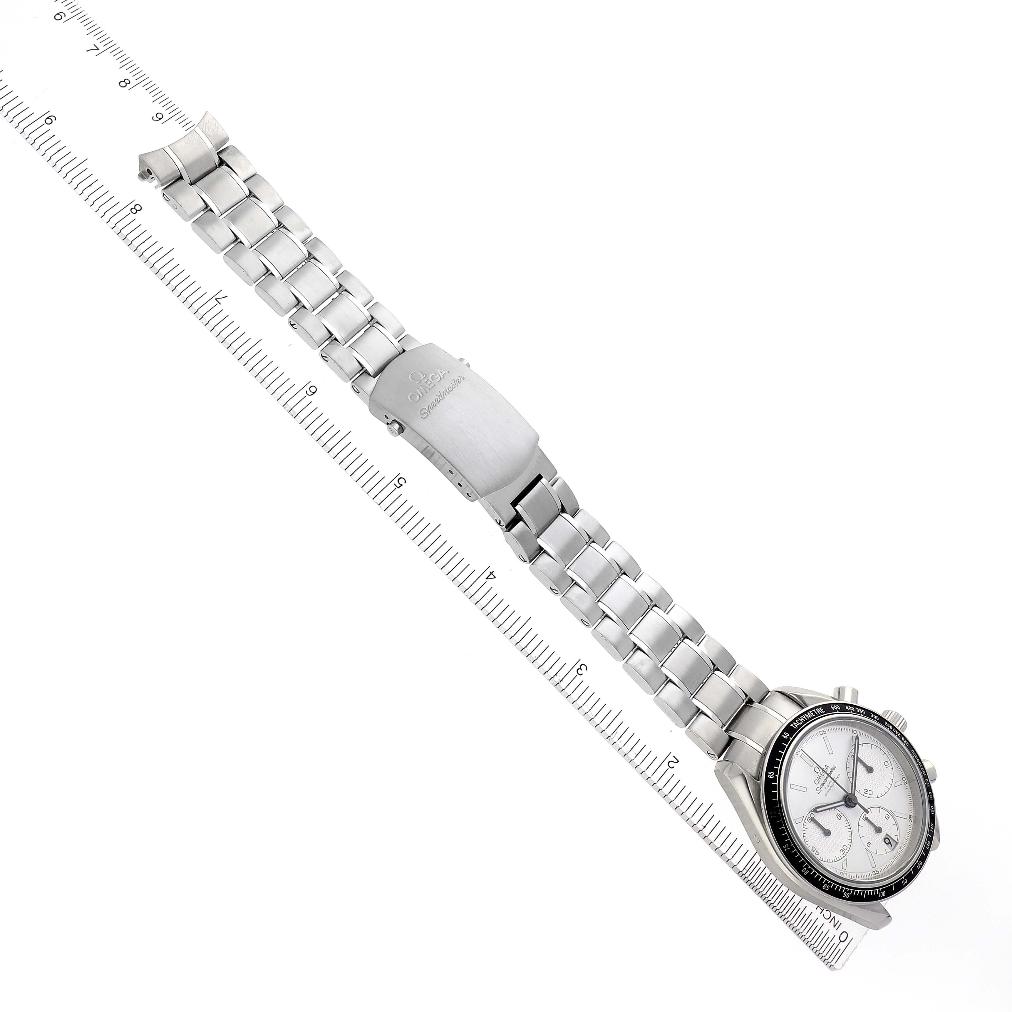 The Omega Speedmaster 326.30.40.50.02.001 Men
s Stainless Steel Silver Dial 326.30.40.50.02.001 Men
s Stainless Steel Silver Dial watch is shown from an angled top view, displaying the face, bezel, and bracelet alongside a ruler.