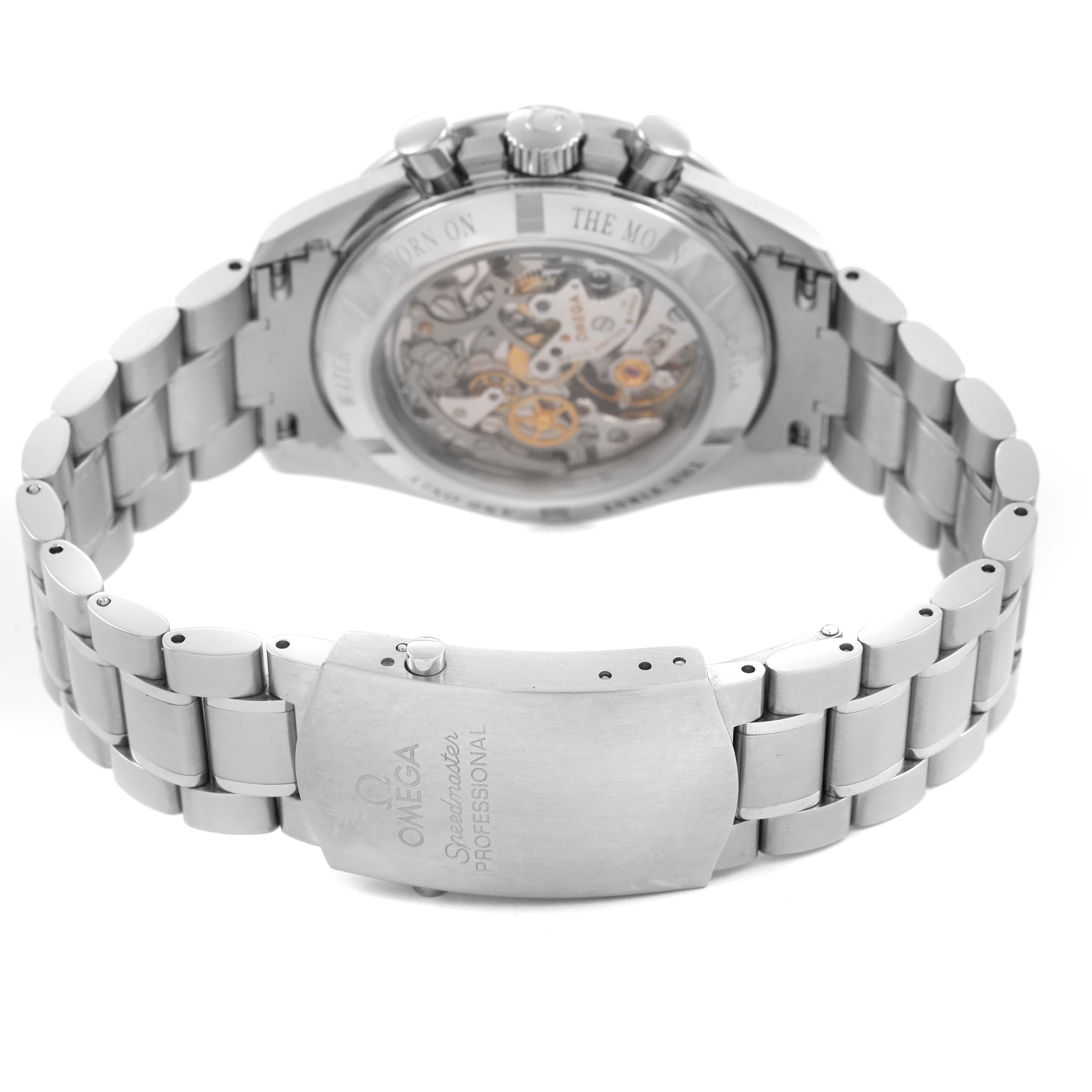The Omega Speedmaster 311.30.42.30.13.001 Men's Stainless Steel Brown Dial watch is shown from the back, displaying its transparent case back, clasp, and part of the bracelet.