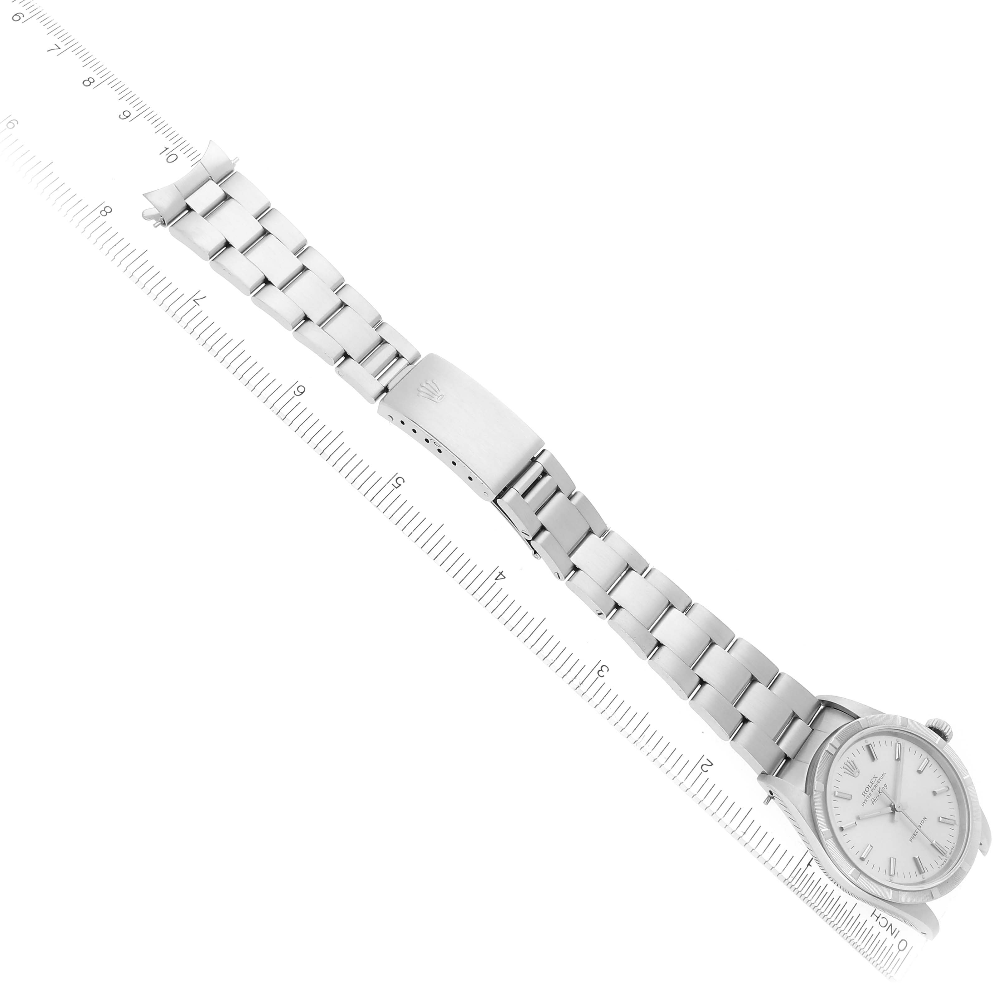 The Rolex Air-King 14010 Men's Stainless Steel Silver Dial 14010 Men's Stainless Steel Silver Dial watch is shown from a top view, displaying the full bracelet and face at an angle beside a ruler.