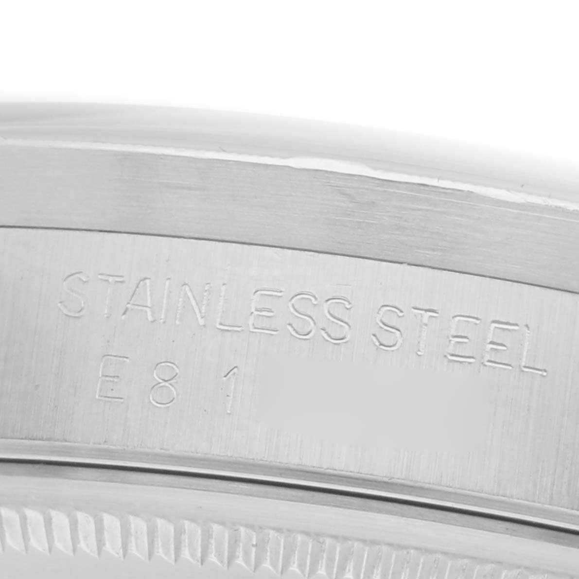 The image shows a close-up of the case edge with engraved writing on a Rolex Air-King 14010 Men's Stainless Steel Silver Dial 14010 Men's Stainless Steel Silver Dial, emphasizing the stainless steel material.