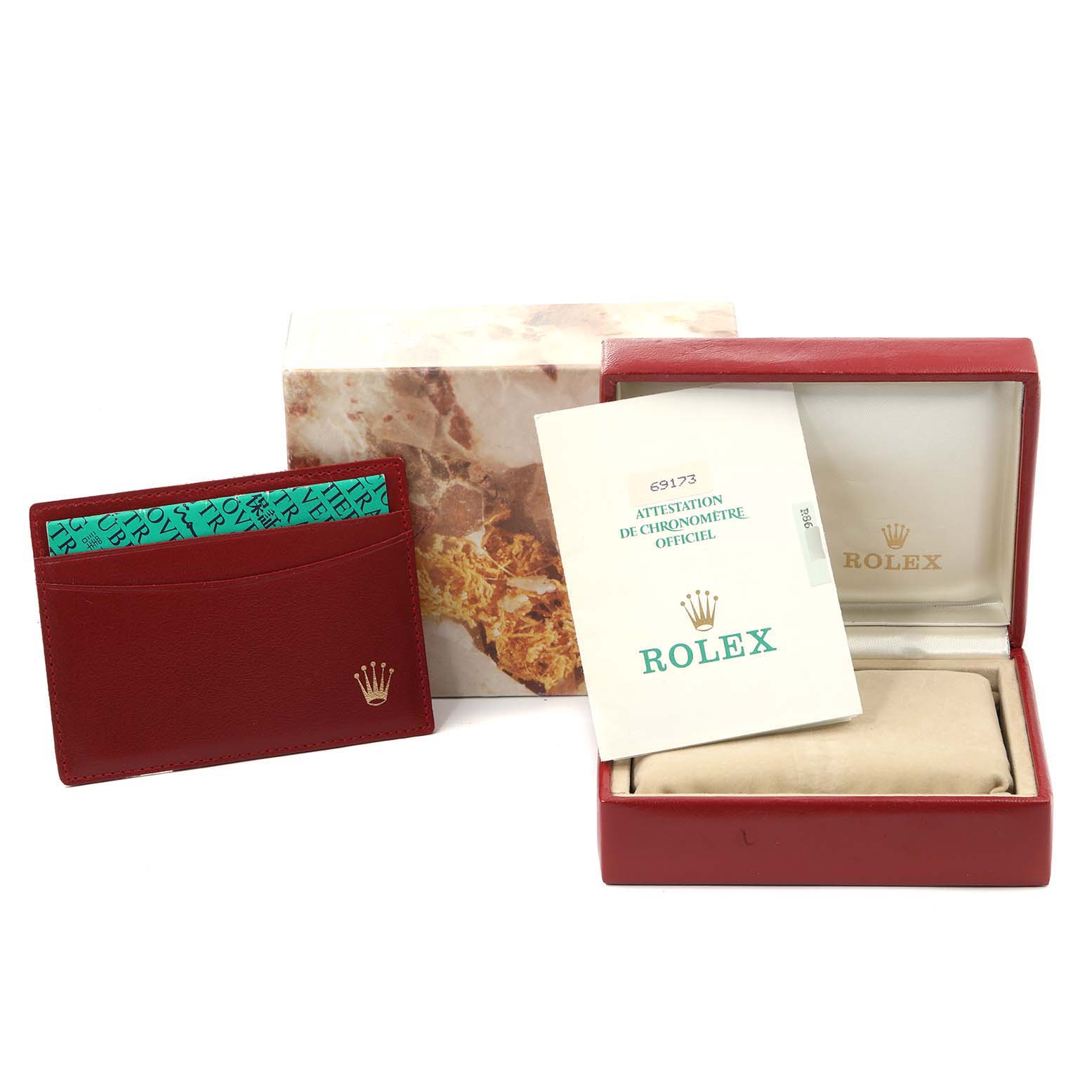 The image shows the packaging and accessories for a Rolex Datejust 69173 Women
s Steel and Gold (two tone) Champagne Dial 69173 Women
s Steel and Gold (two tone) Champagne Dial model, including a box, cardholder, and official certification document.