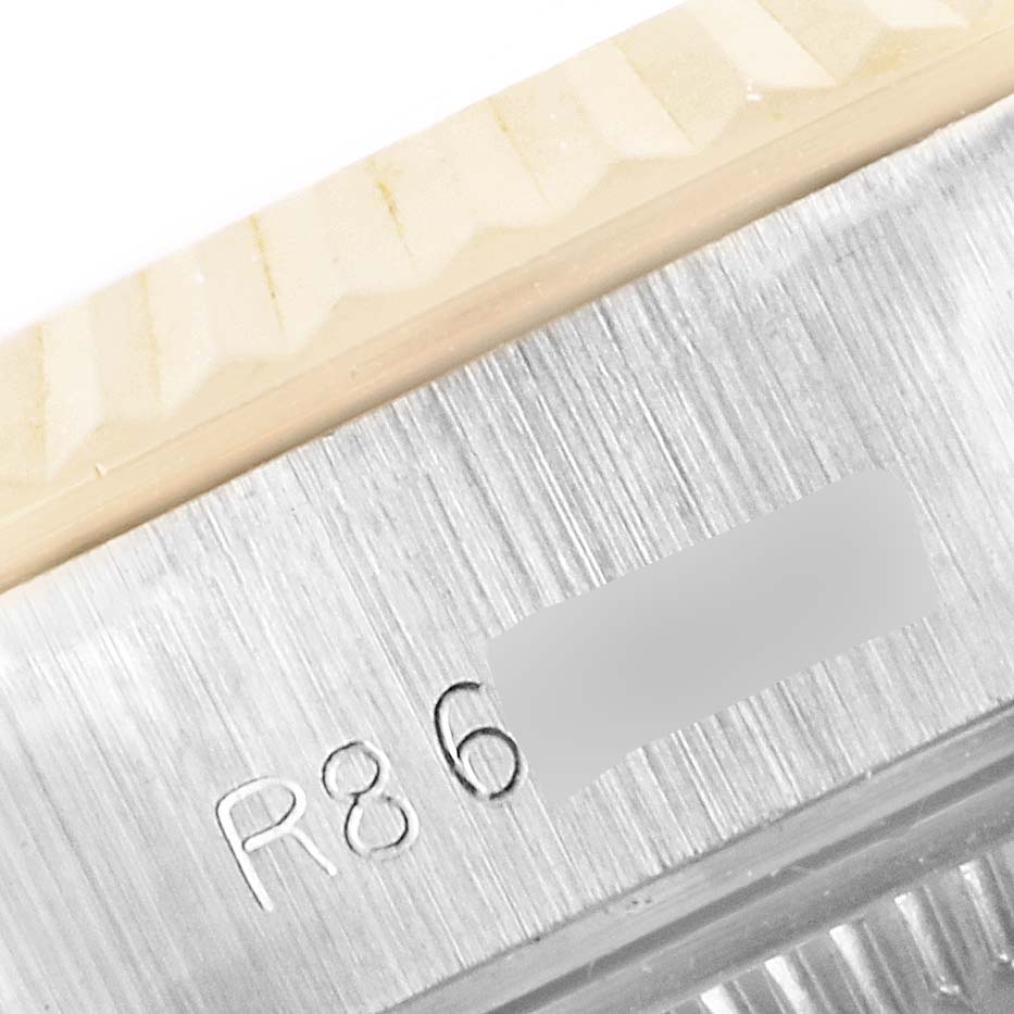 This close-up angle shows part of the bezel and the serial engraving of the Rolex Datejust 69173 Women
s Steel and Gold (two tone) Champagne Dial 69173 Women
s Steel and Gold (two tone) Champagne Dial watch.