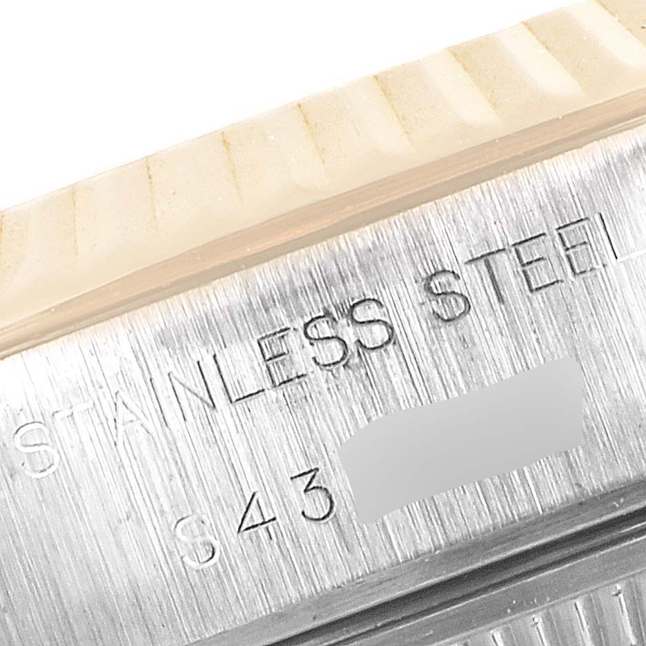 This image shows a close-up of the bezel and case side of a Rolex Datejust 69173 Women's Steel and Gold (two tone) Black Dial 69173 Women's Steel and Gold (two tone) Black Dial watch, displaying the stamped "STAINLESS STEEL" text.