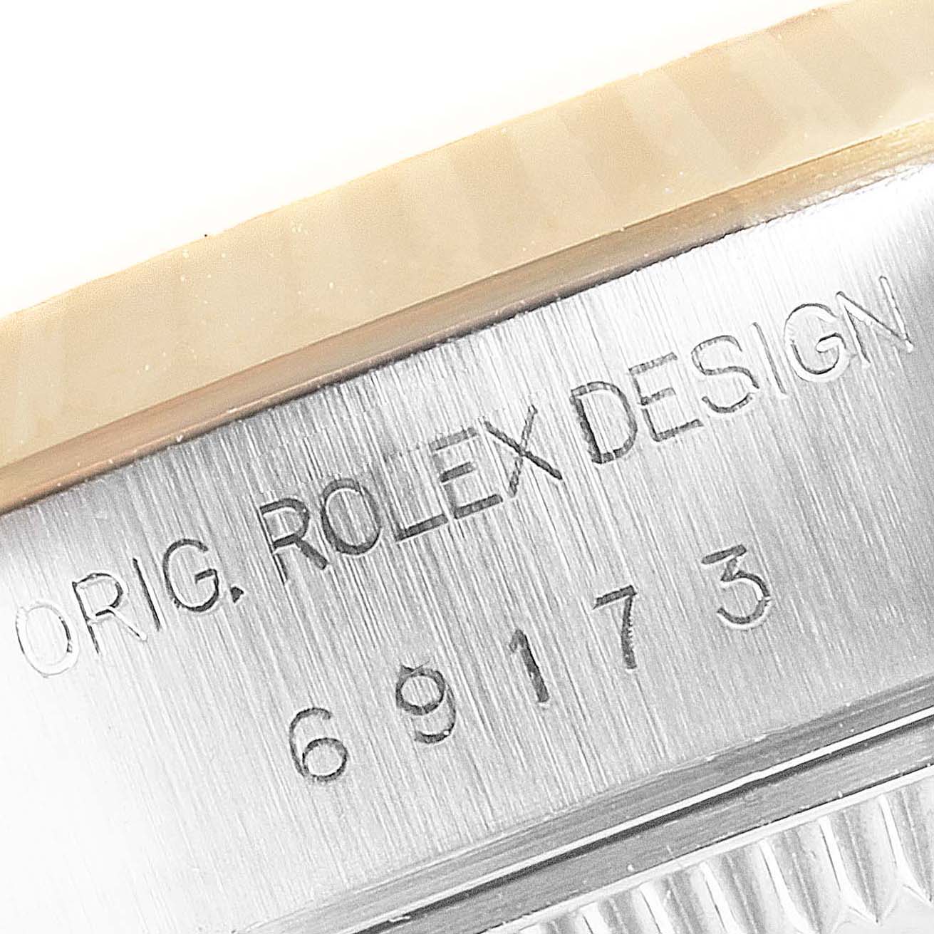 Close-up of the case side showing engraving on a Rolex Datejust 69173 Women's Steel and Gold (two tone) Black Dial 69173 Women's Steel and Gold (two tone) Black Dial model.