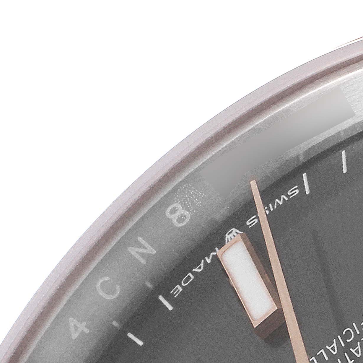 The image shows a close-up of the upper-right portion of a Rolex Datejust 116201 Men
s Steel and Gold (two tone) Grey Dial 116201 Men
s Steel and Gold (two tone) Grey Dial watch face, including part of the number 8, hands, and markers.