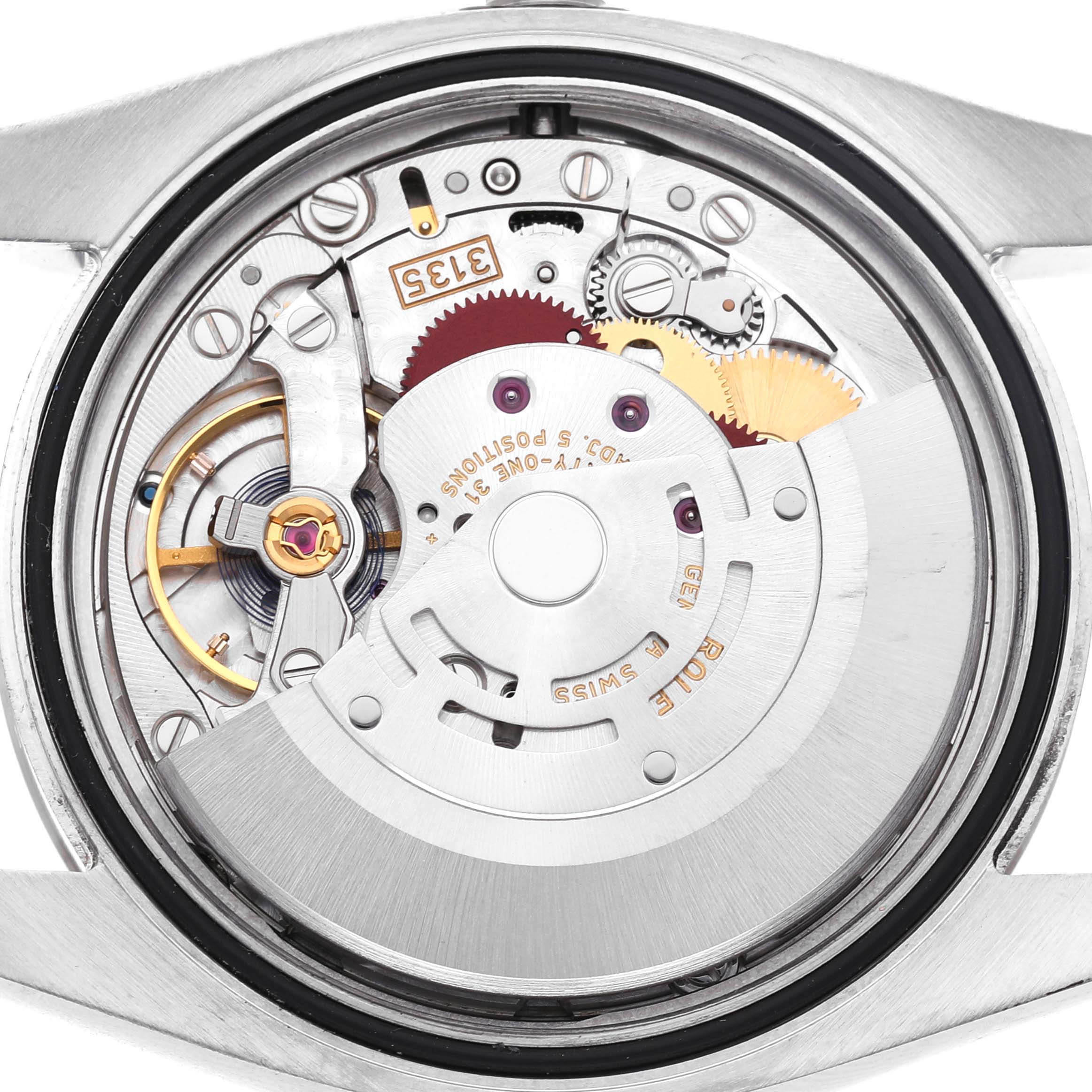 The image shows the back view of a Rolex Datejust 116234 Men's Stainless Steel Silver Dial, highlighting the movement and inner mechanics.