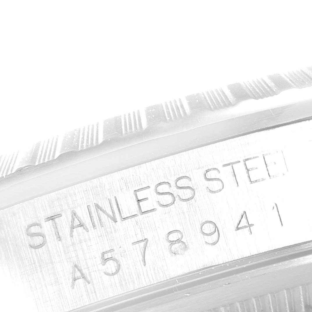 The close-up image shows the stainless steel bezel and serial number of a Rolex Datejust 16220 Men's Stainless Steel Black Dial 16220 Men's Stainless Steel Black Dial watch.