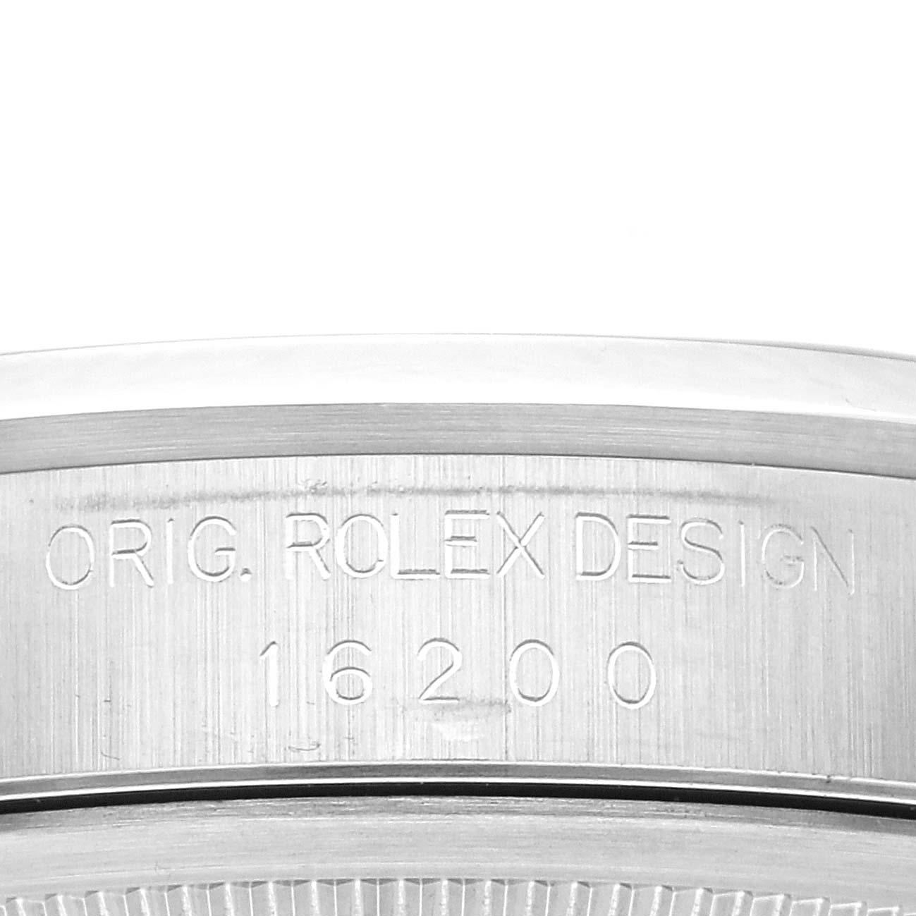 The image shows a close-up view of the side engraving on the Rolex Datejust 16200 Men's Stainless Steel Blue Dial 16200 Men's Stainless Steel Blue Dial watch case, displaying "ORIG. ROLEX DESIGN 16200".