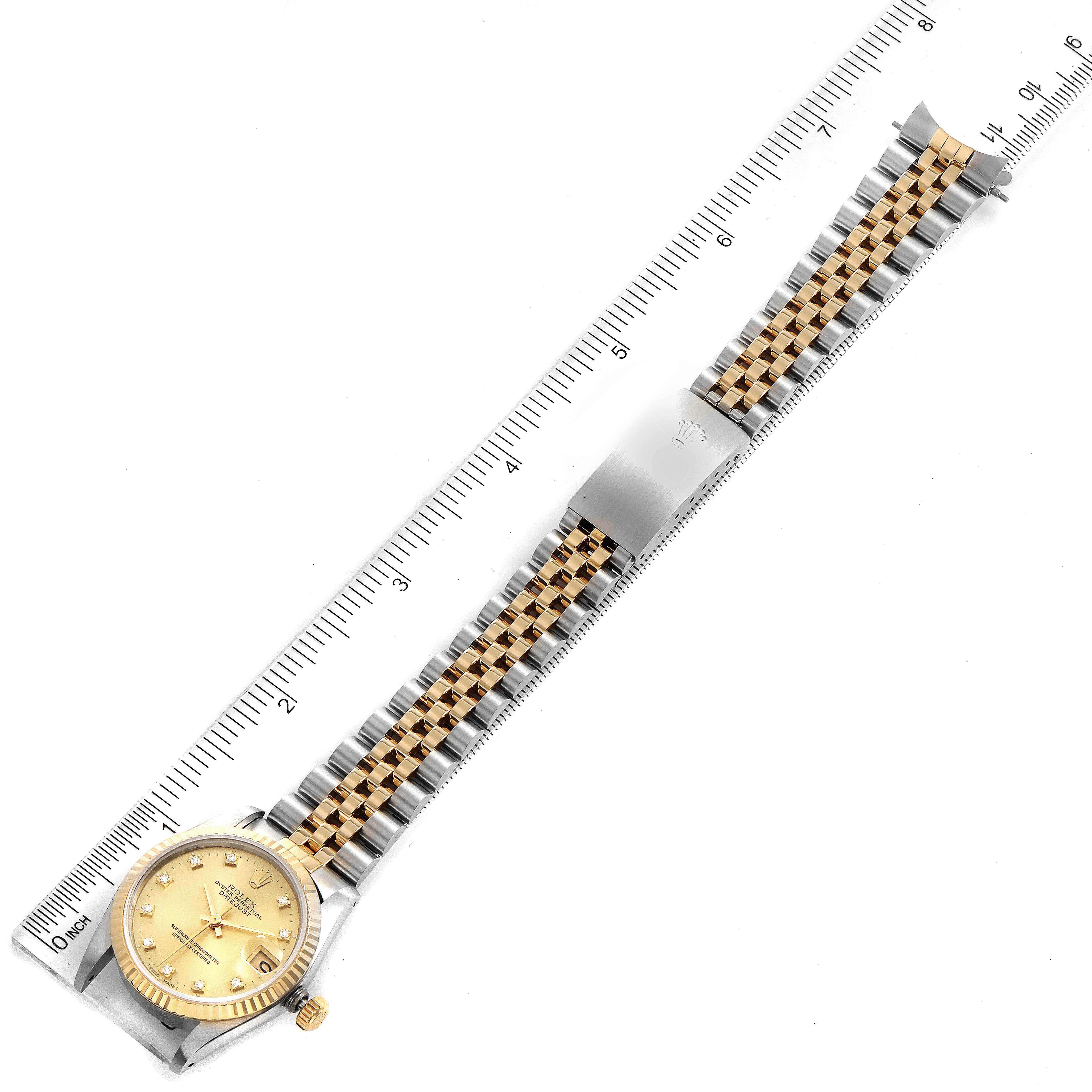 The image shows a Rolex Mid-Size 68273 Women's Steel and Gold (two tone) Champagne Dial 68273 Women's Steel and Gold (two tone) Champagne Dial watch laid out flat with its face and full bracelet visible, placed alongside a ruler for scale.