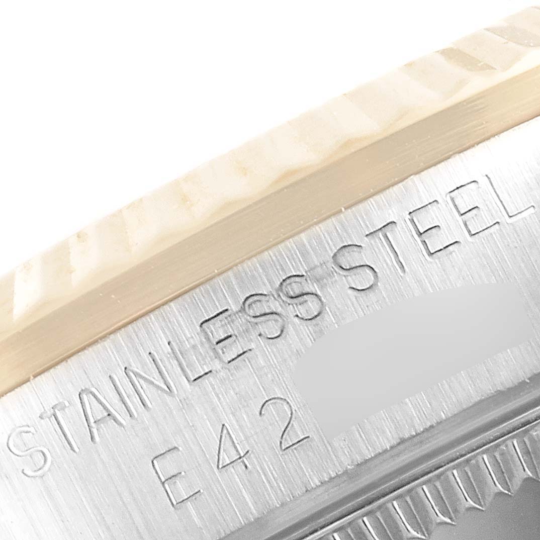 Close-up view of the side case of a Rolex Mid-Size 68273 Women's Steel and Gold (two tone) Champagne Dial 68273 Women's Steel and Gold (two tone) Champagne Dial model watch, showing the "STAINLESS STEEL" engraving.