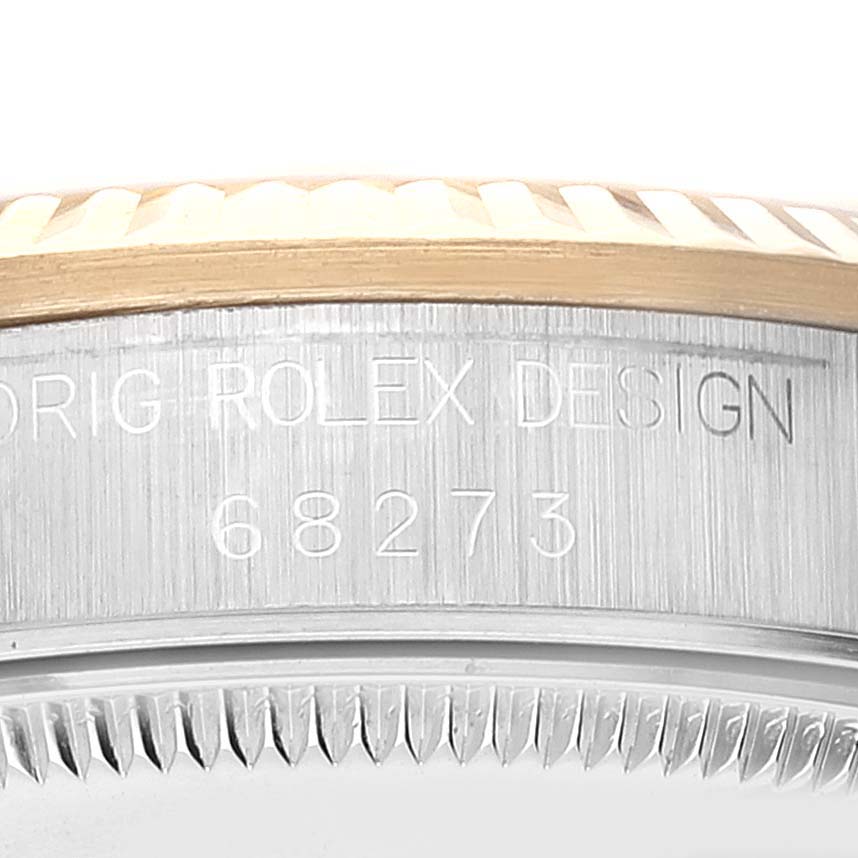 This image shows the engraved casing side of a Mid-Size Rolex watch, featuring its model number 68273 and "ORIG ROLEX DESIGN" inscription.