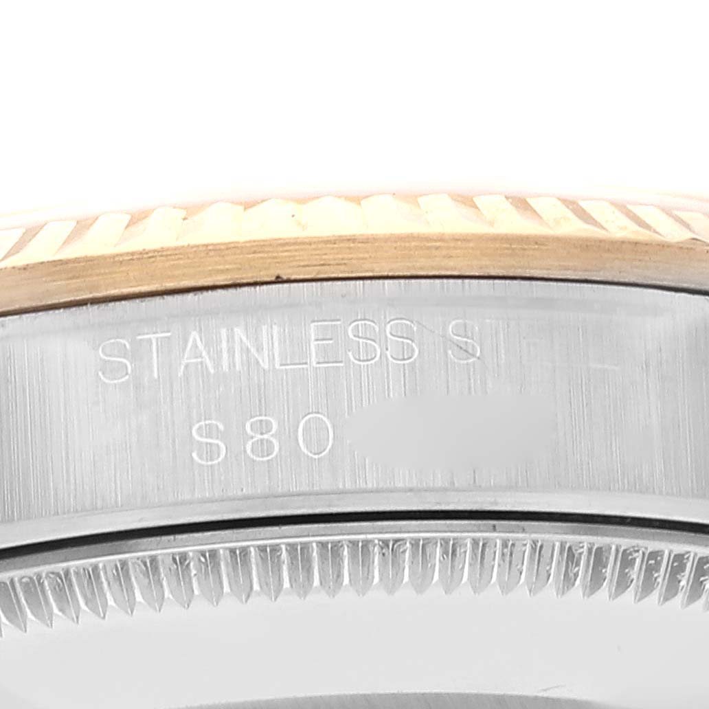 The image shows a close-up of the side engraving on a Mid-Size Rolex watch case, indicating stainless steel material.